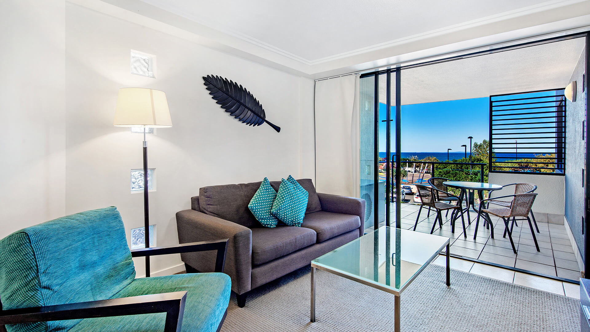 Living area with balcony in 2 Bedroom Apartment at ULTIQA Shearwater Resort.