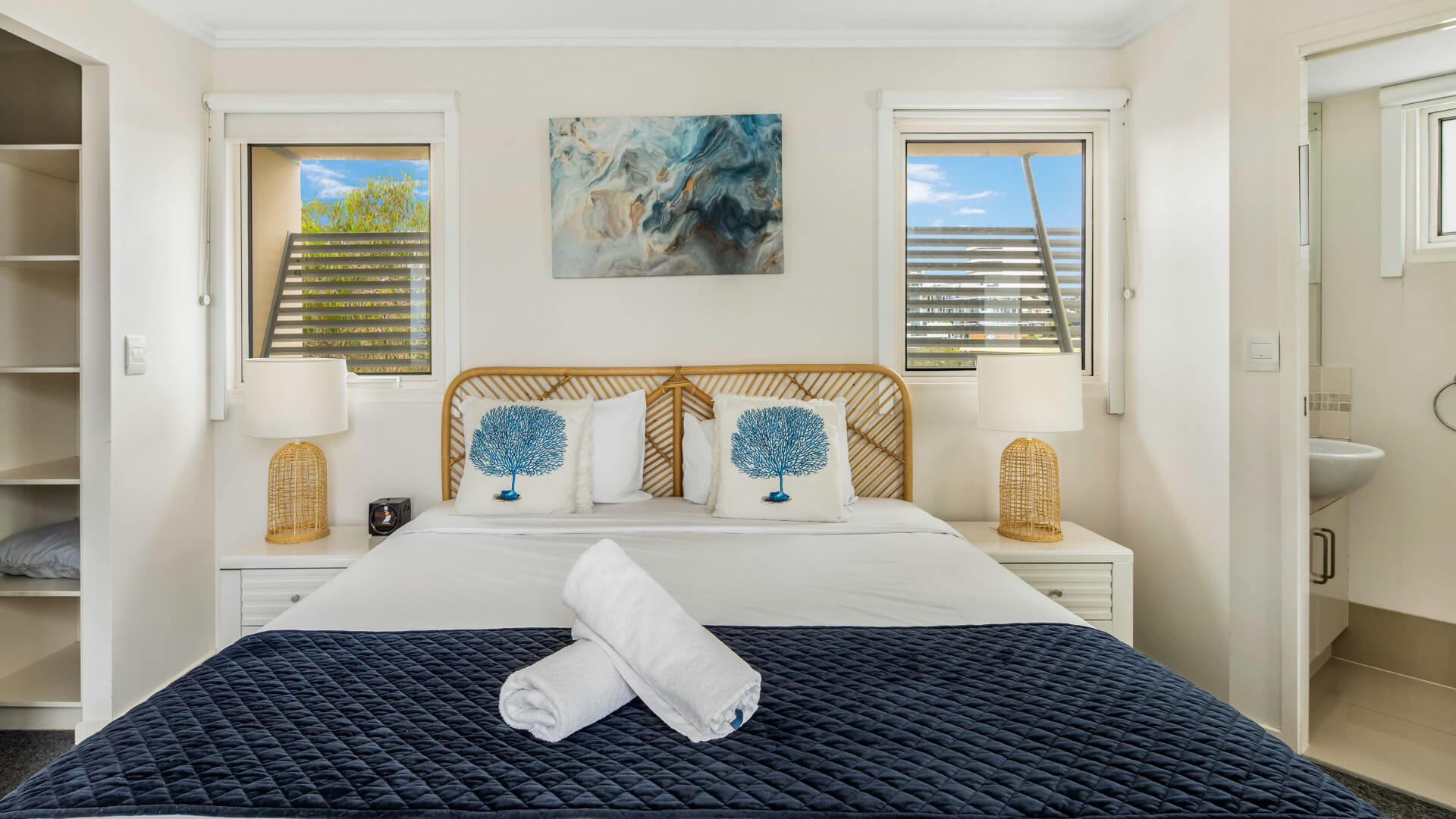 Bedroom with king bed, ensuite, and natural light in 3 Bedroom Penthouse at ULTIQA Shearwater Resort.