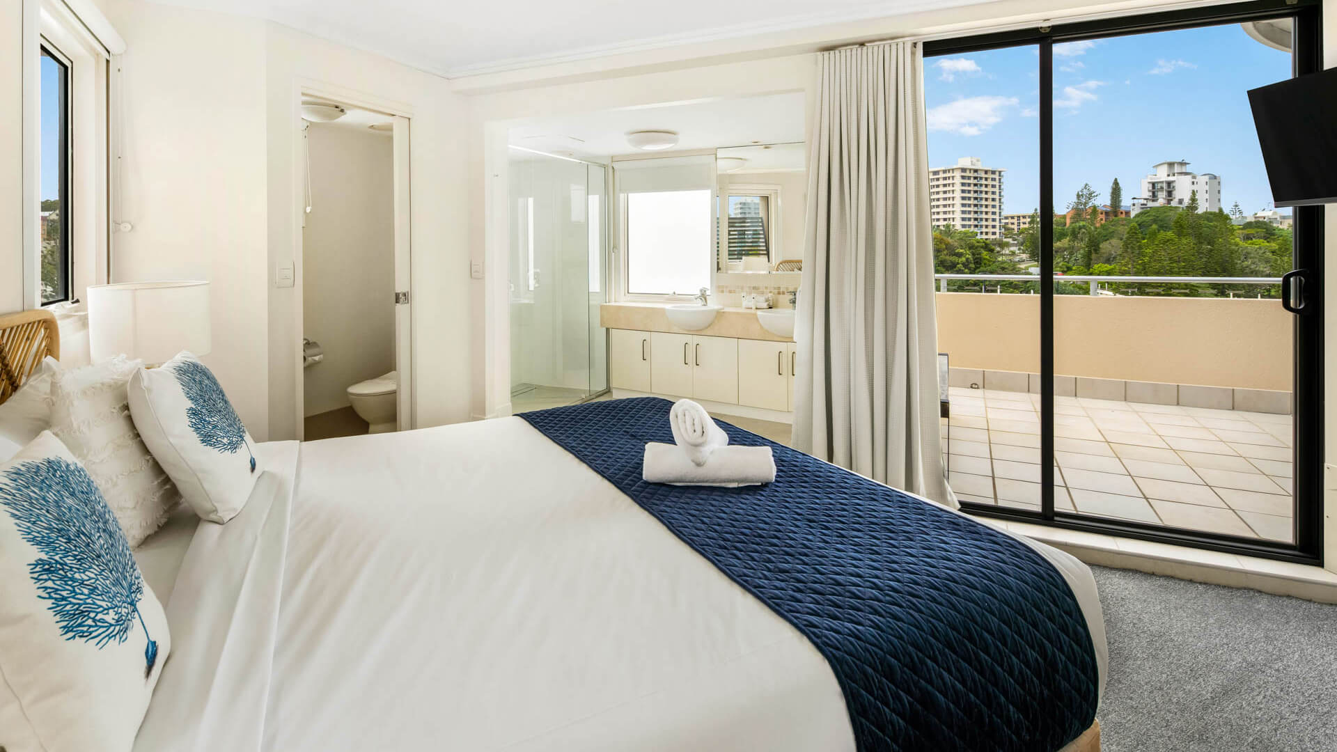 Bedroom with king bed, ensuite, and balcony access in 3 Bedroom Penthouse at ULTIQA Shearwater Resort.