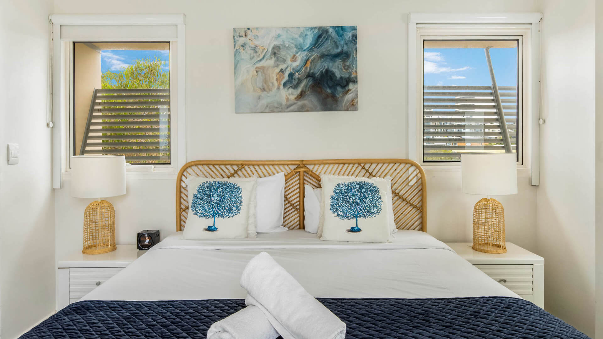 Bedroom with king bed and coastal décor in 3 Bedroom Penthouse at ULTIQA Shearwater Resort.