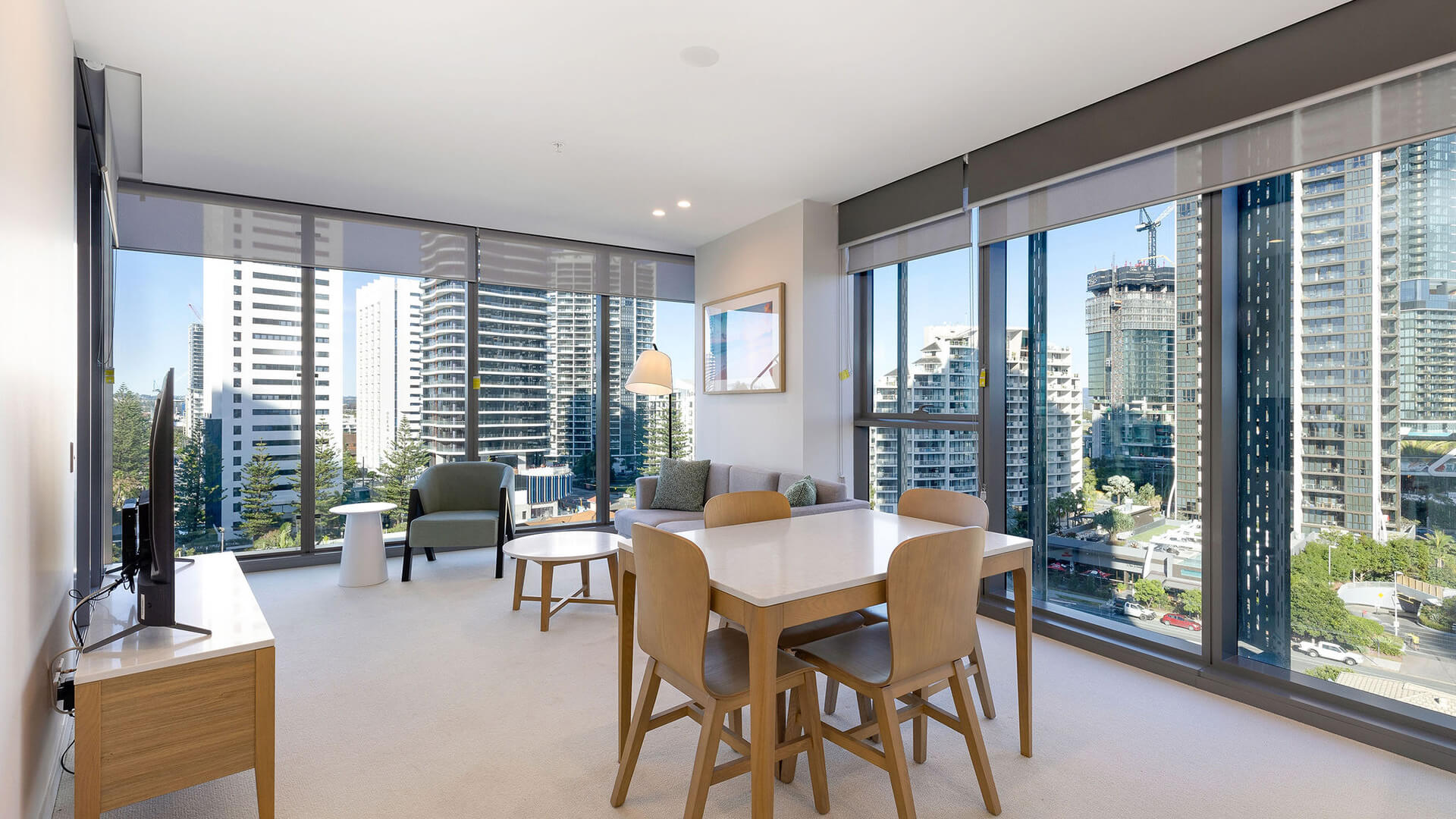 Open-plan living and dining area with city views in the 1 Bedroom Suite at ULTIQA Signature at Broadbeach.