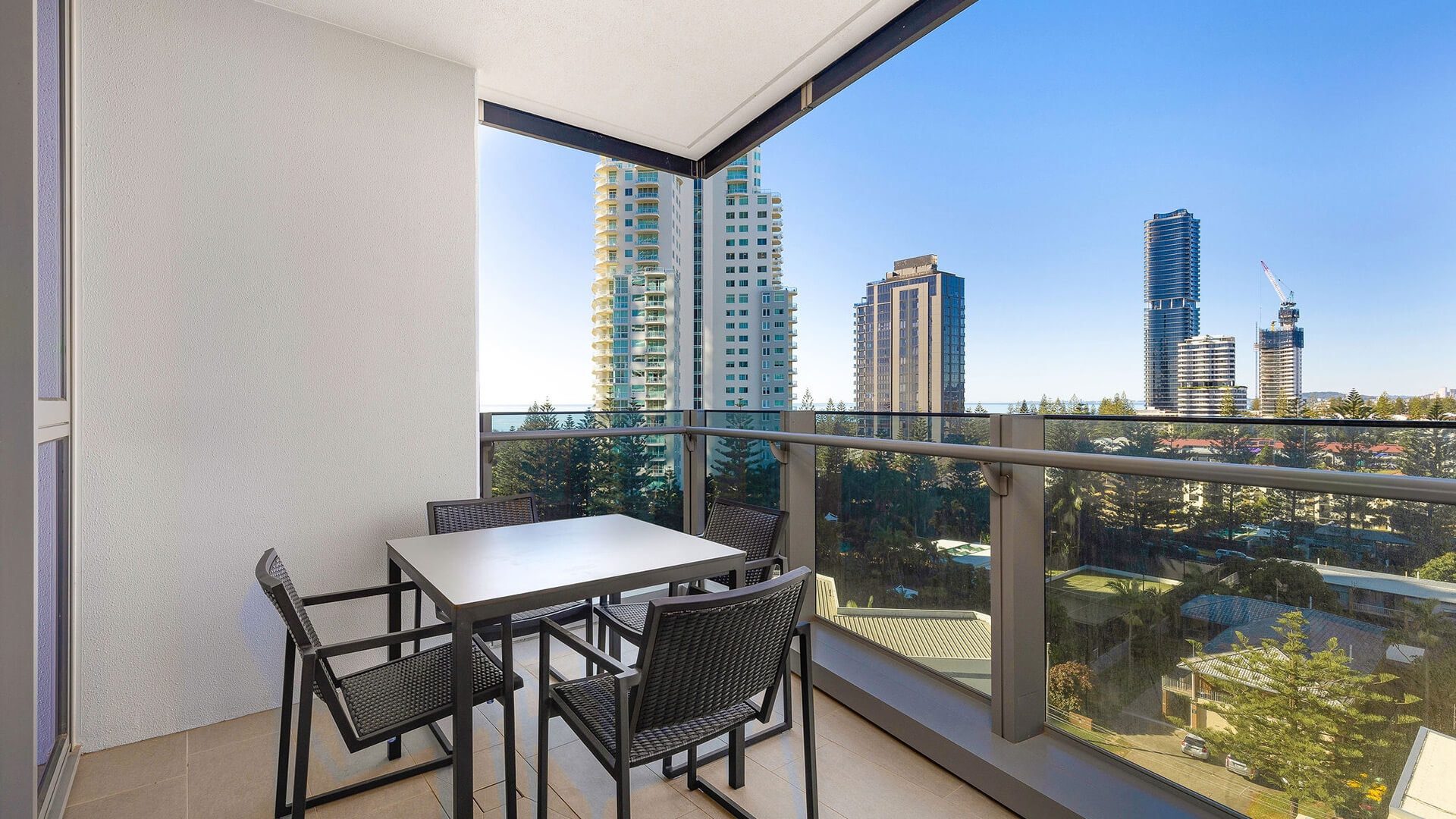 Private balcony with outdoor dining and city views in the 1 Bedroom Suite at ULTIQA Signature at Broadbeach.
