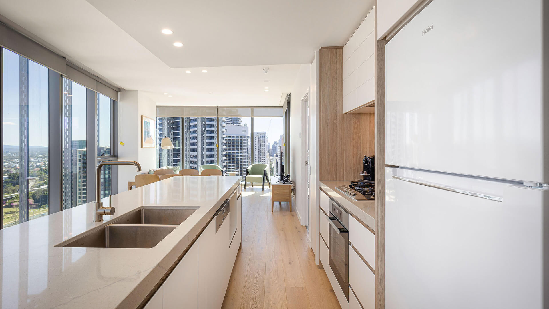 Kitchen in 2 Bedroom Suite at ULTIQA Signature at Broadbeach with island bench, modern appliances, and city views.