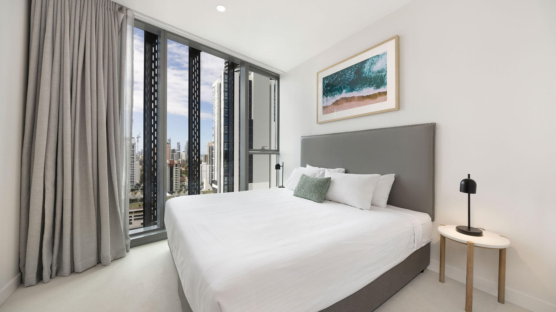 Bedroom with king bed, city views, and modern décor in the 2 Bedroom Skyhome at ULTIQA Signature at Broadbeach.