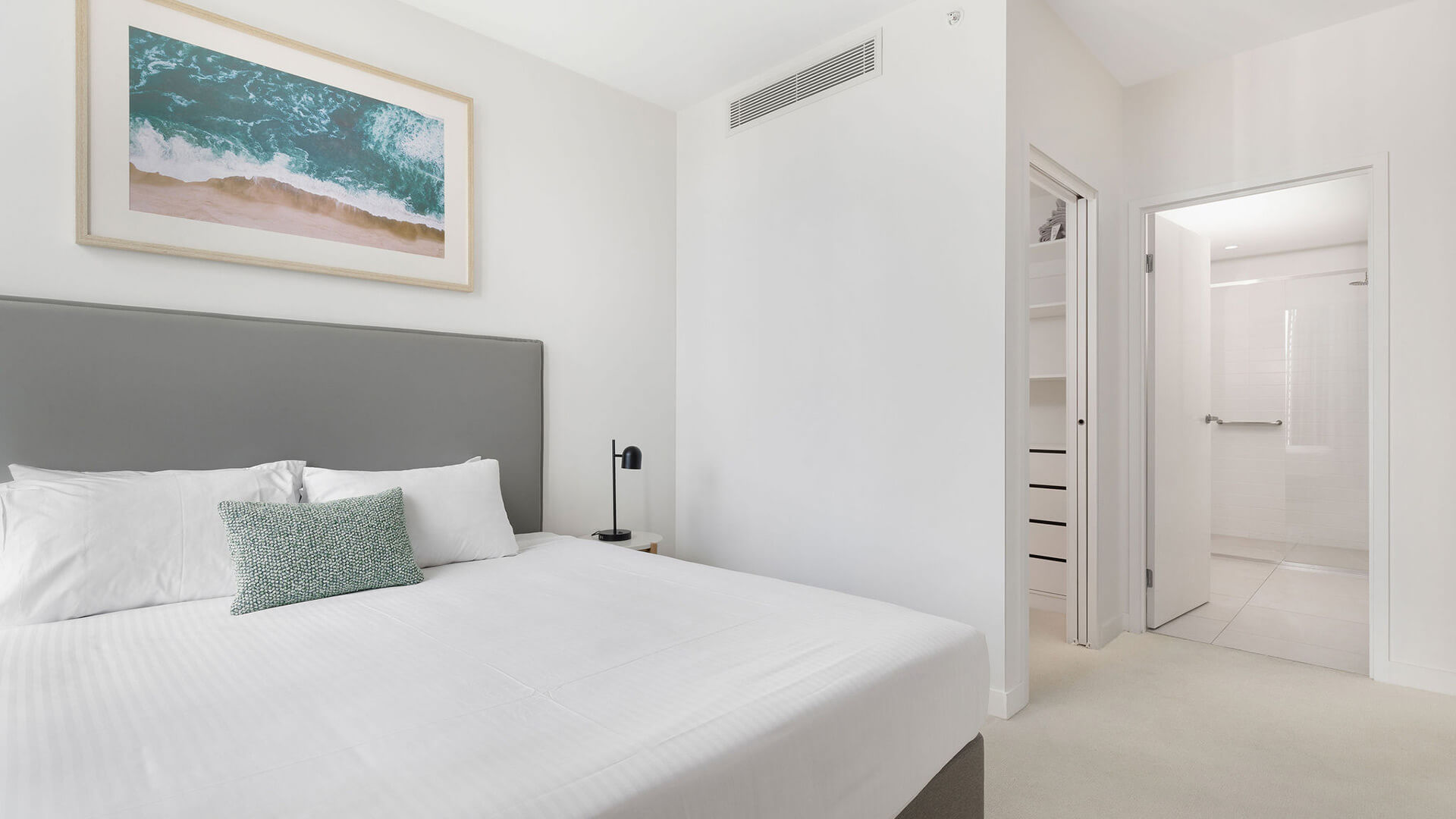 Bedroom with king bed, walk-in wardrobe, and ensuite access in the 2 Bedroom Skyhome at ULTIQA Signature at Broadbeach.