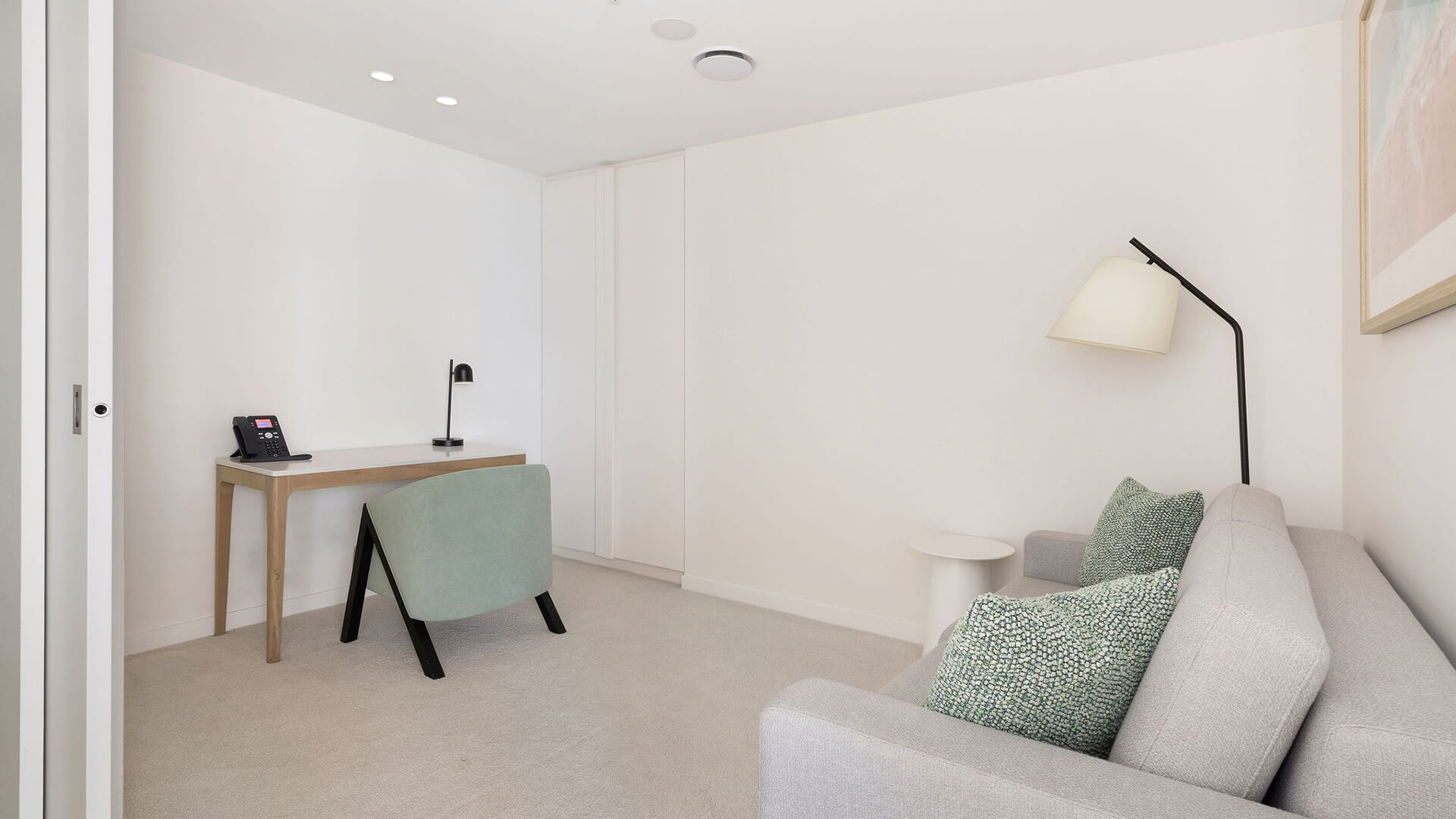 Study nook with desk, chair, and sofa in the 2 Bedroom Skyhome at ULTIQA Signature at Broadbeach.