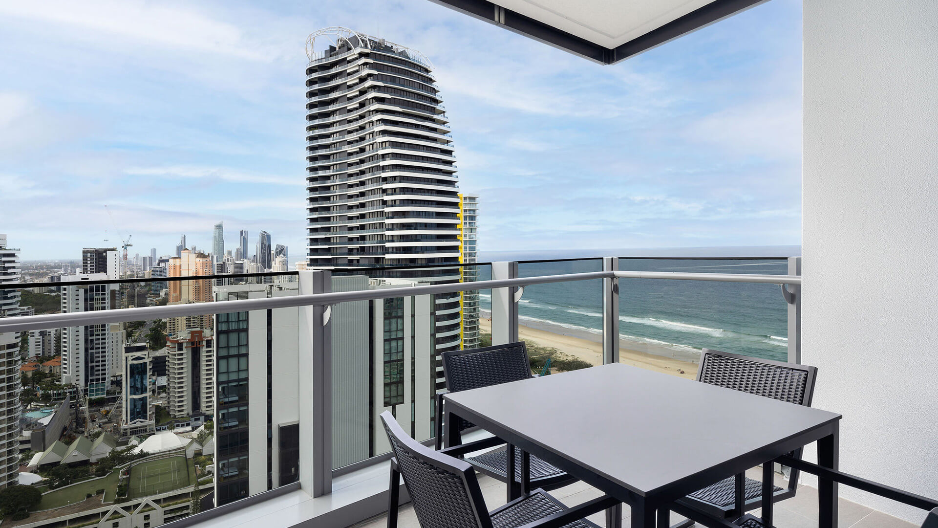 Private balcony with outdoor dining and ocean views in the 2 Bedroom Skyhome at ULTIQA Signature at Broadbeach.