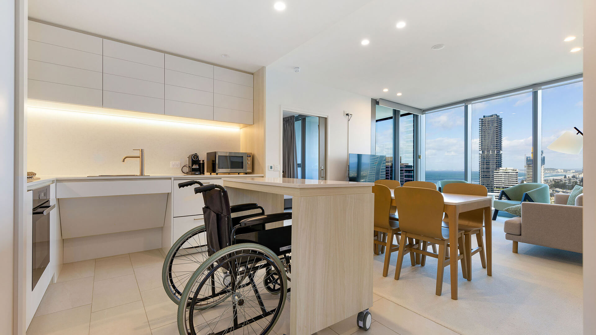 Accessible kitchen and dining area with wheelchair access and ocean views in 2 Bedroom Accessible Suite at ULTIQA Signature at Broadbeach.