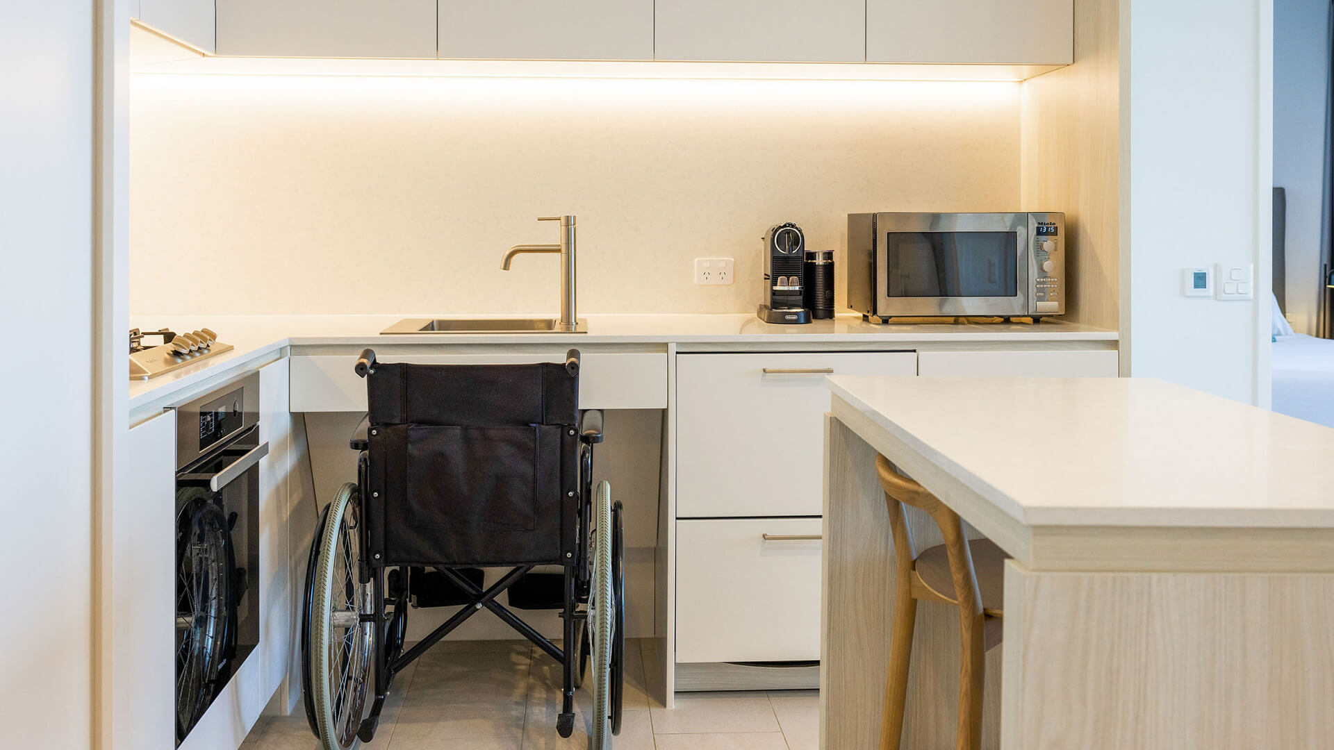 Wheelchair-accessible kitchen in 2 Bedroom Accessible Suite at ULTIQA Signature at Broadbeach.