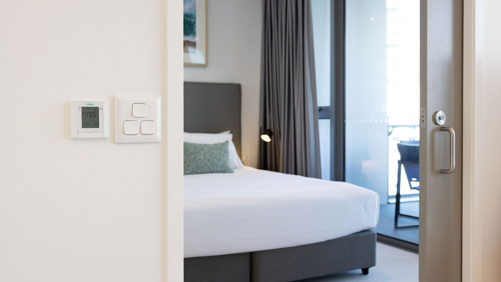 Bedroom with balcony access in 2 Bedroom Accessible Suite at ULTIQA Signature at Broadbeach.
