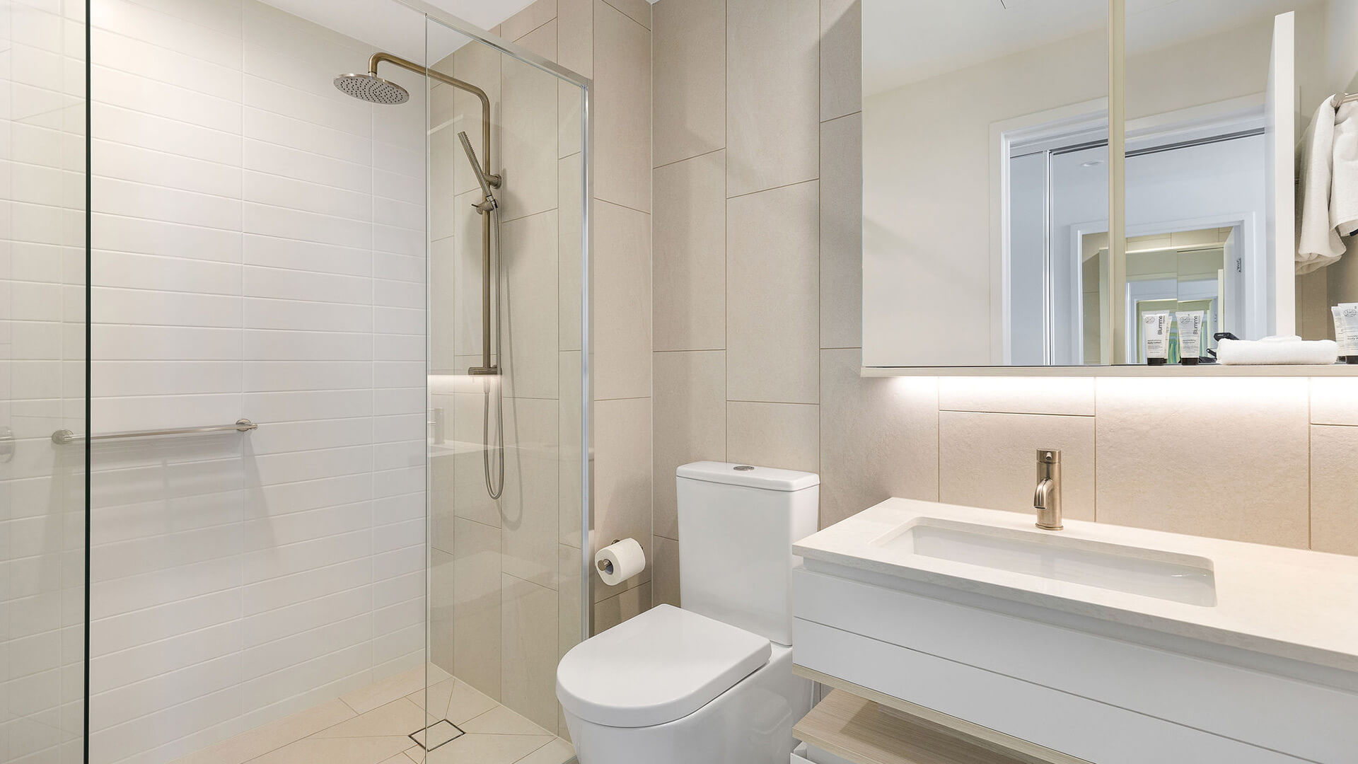 Modern bathroom with walk-in shower in the 2 Bedroom Ocean View Suite at ULTIQA Signature at Broadbeach.