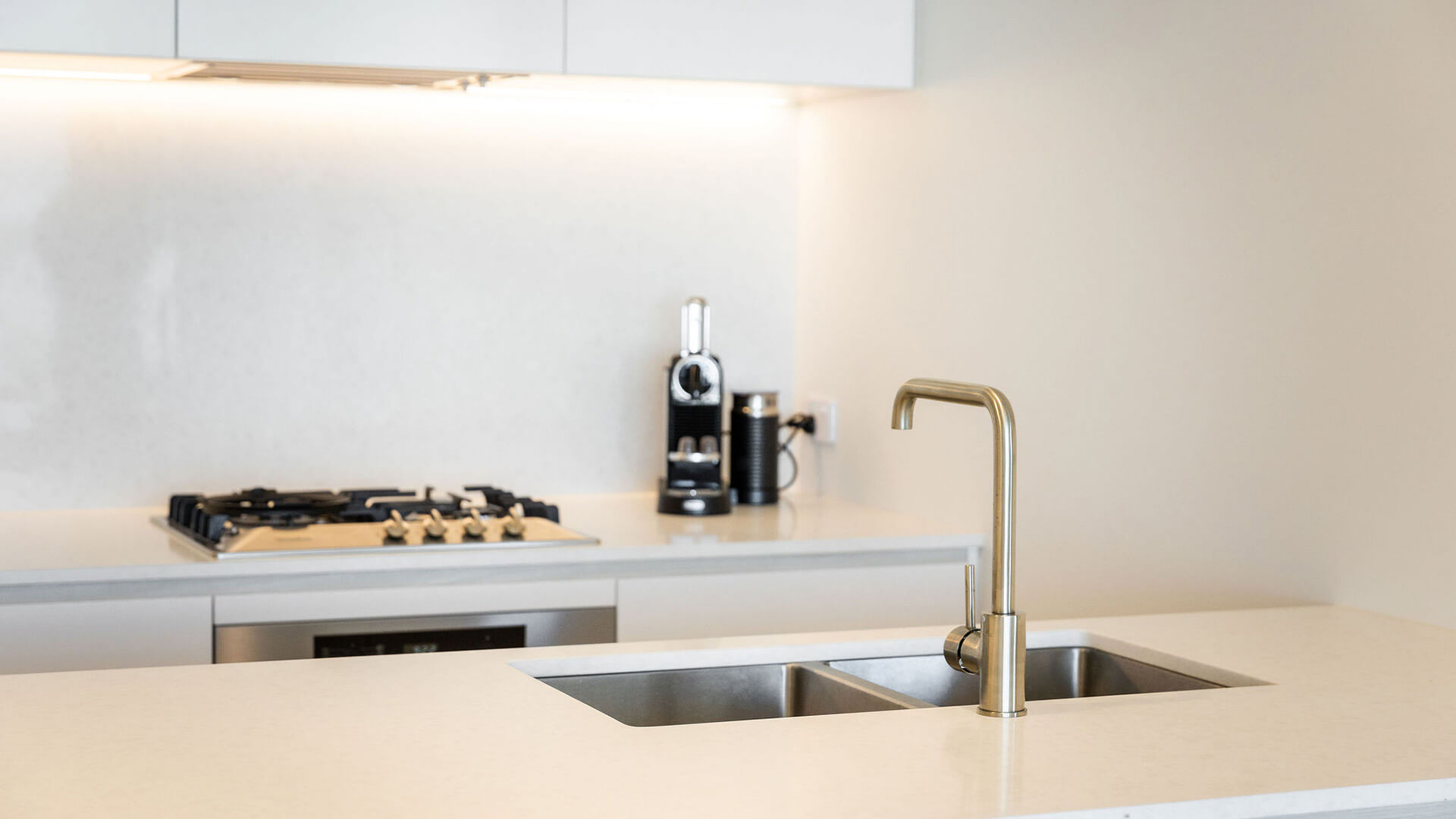 Close-up of kitchen sink and stovetop in the 2 Bedroom Ocean View Suite at ULTIQA Signature at Broadbeach.