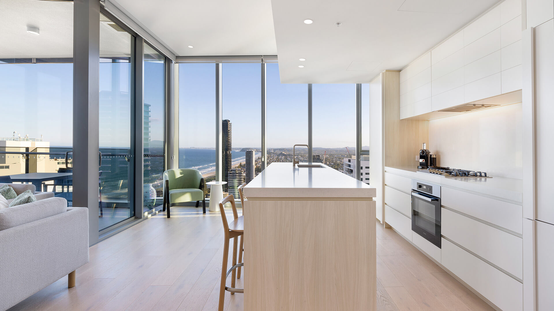 Modern kitchen with panoramic coastline views in the 2 Bedroom Ocean View Suite Premium at ULTIQA Signature at Broadbeach.