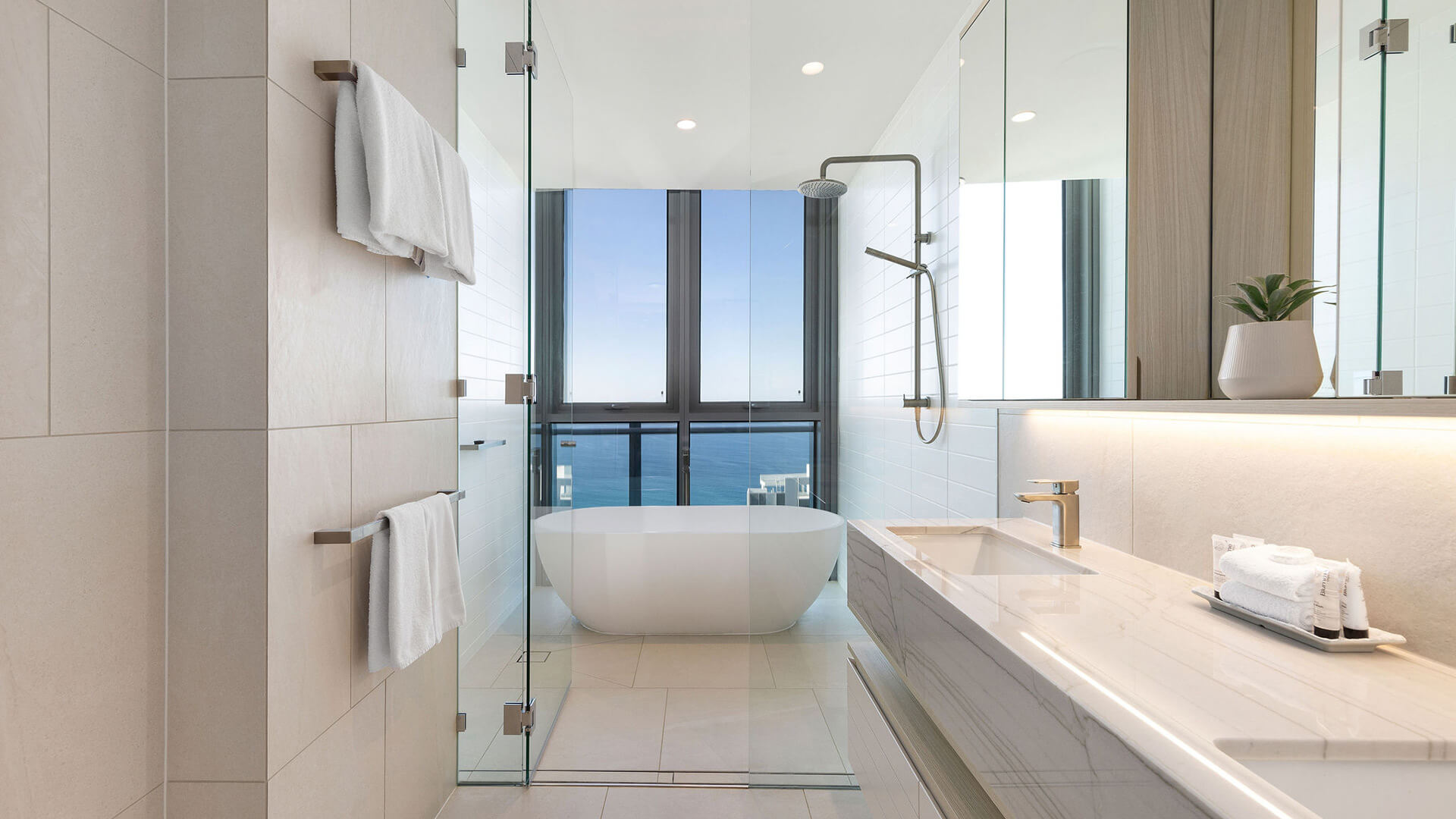Bathroom in 3 Bedroom Ocean Sub-Penthouse at ULTIQA Signature at Broadbeach with ocean-view bathtub and walk-in shower.