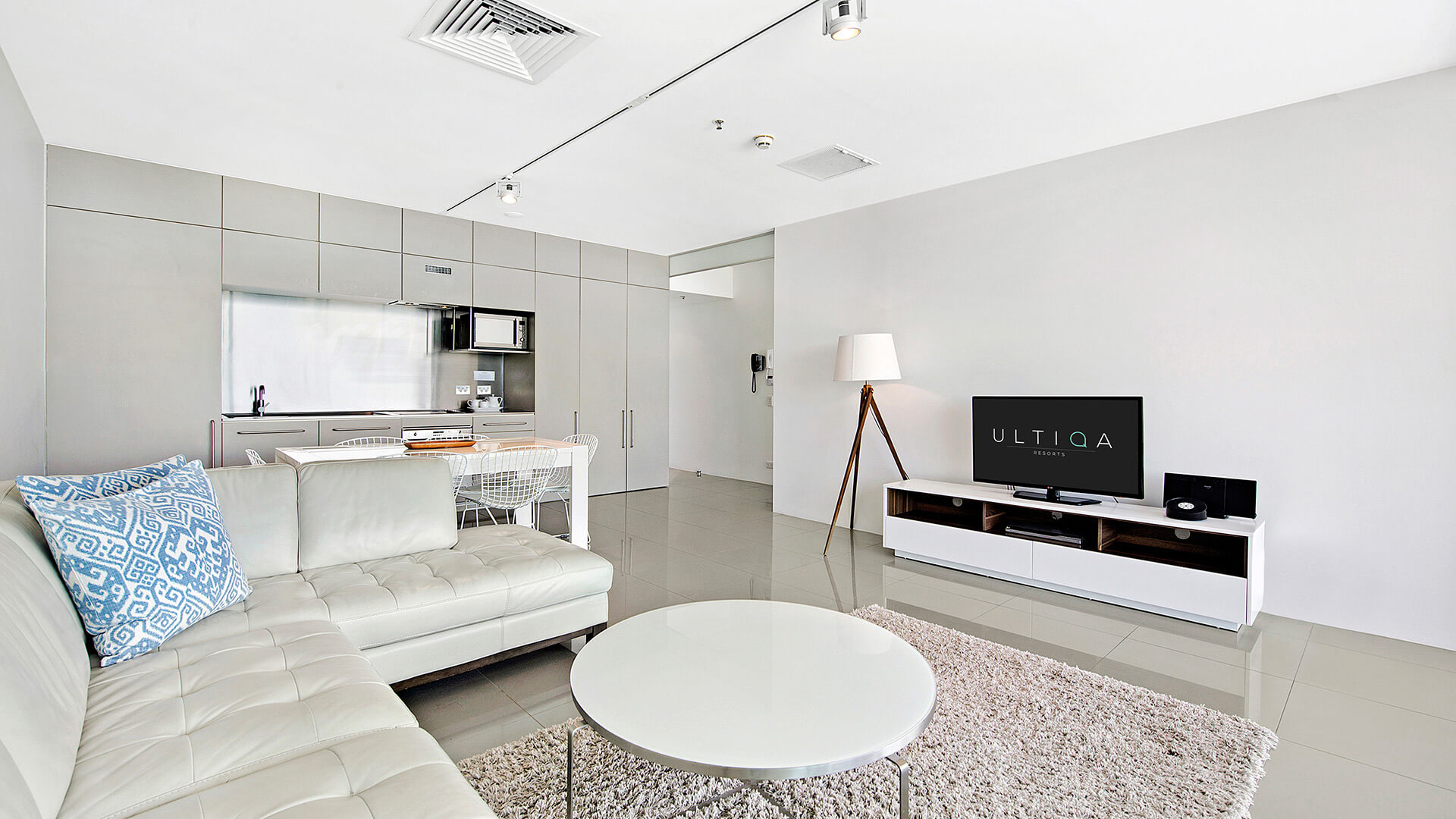 Open-plan living room with kitchen in 1 Bedroom Ocean View Apartment at ULTIQA Air on Broadbeach.