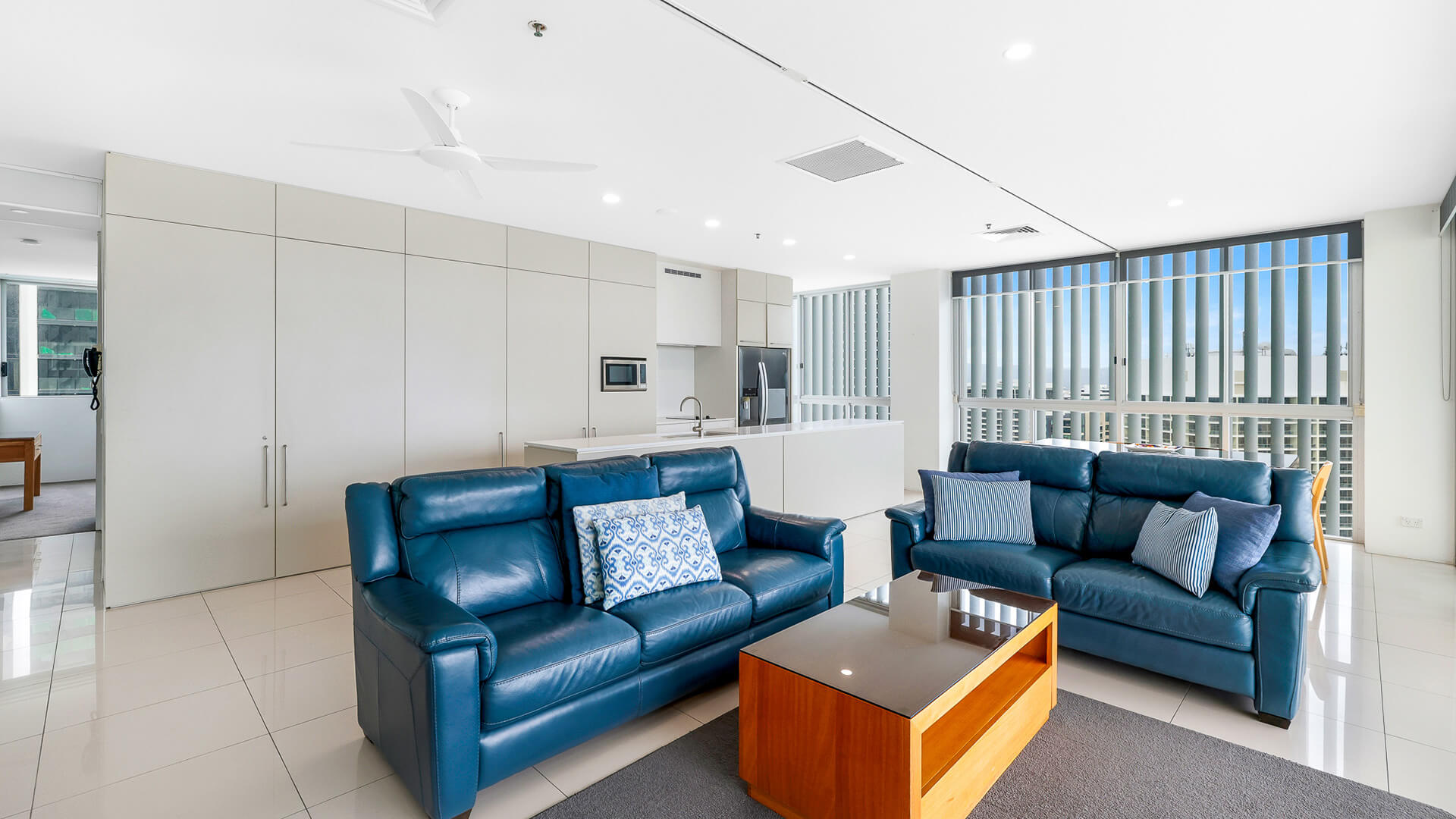 Modern open-plan lounge and kitchen in 2 Bedroom Gold Coast View Suite at ULTIQA Air on Broadbeach.