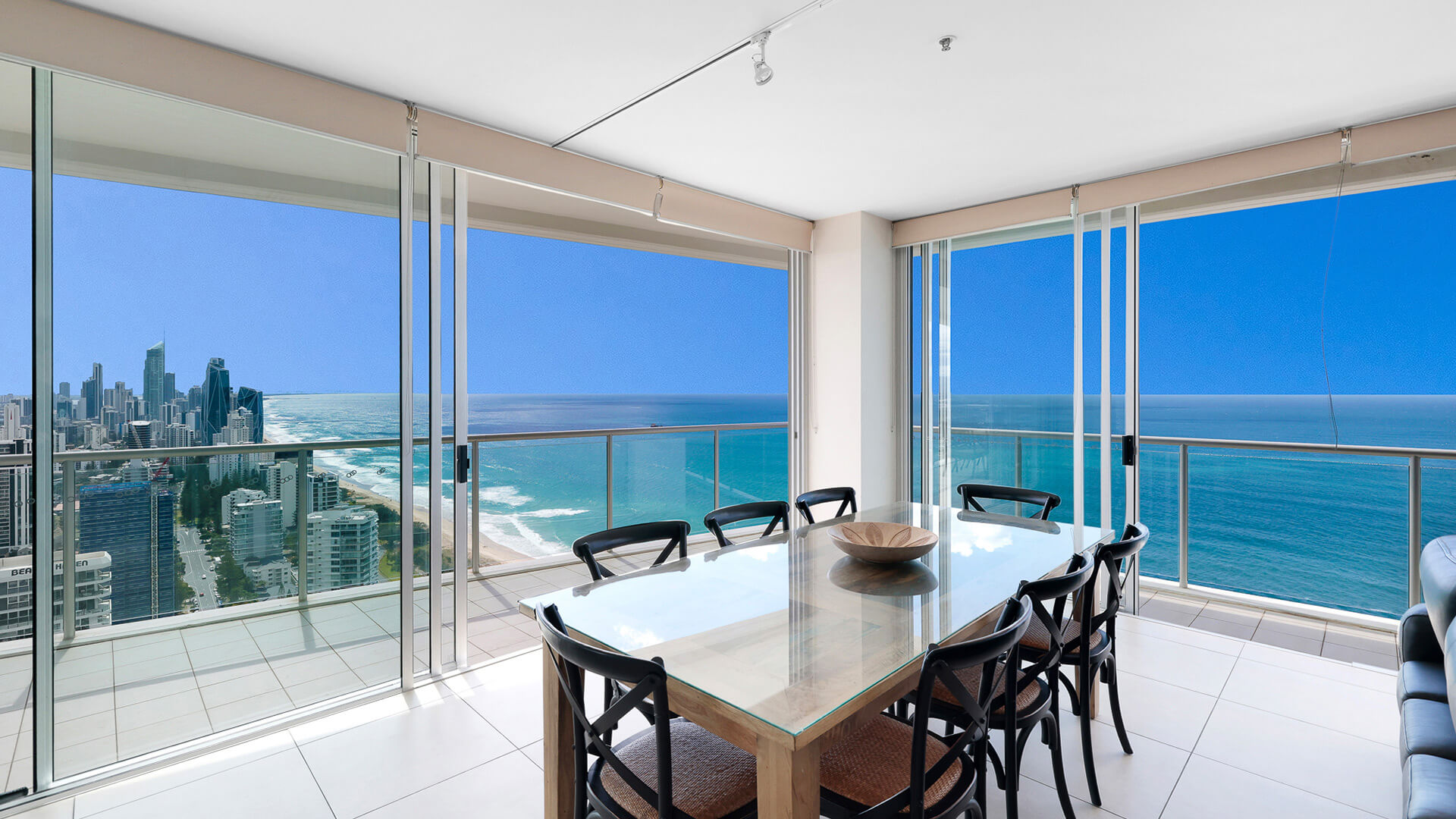 Dining area with panoramic ocean and city views in 4 Bedroom Ocean View Apartment at ULTIQA Air on Broadbeach.