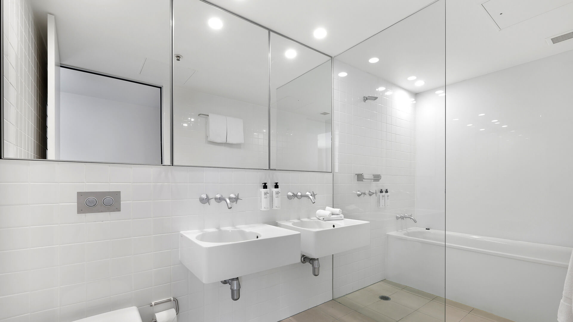 Bathroom with double vanity and bathtub in 4 Bedroom Ocean View Apartment at ULTIQA Air on Broadbeach.