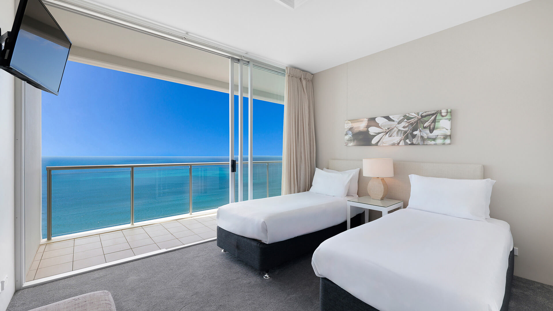 Twin bedroom with ocean view balcony in 4 Bedroom Ocean View Apartment at ULTIQA Air on Broadbeach.