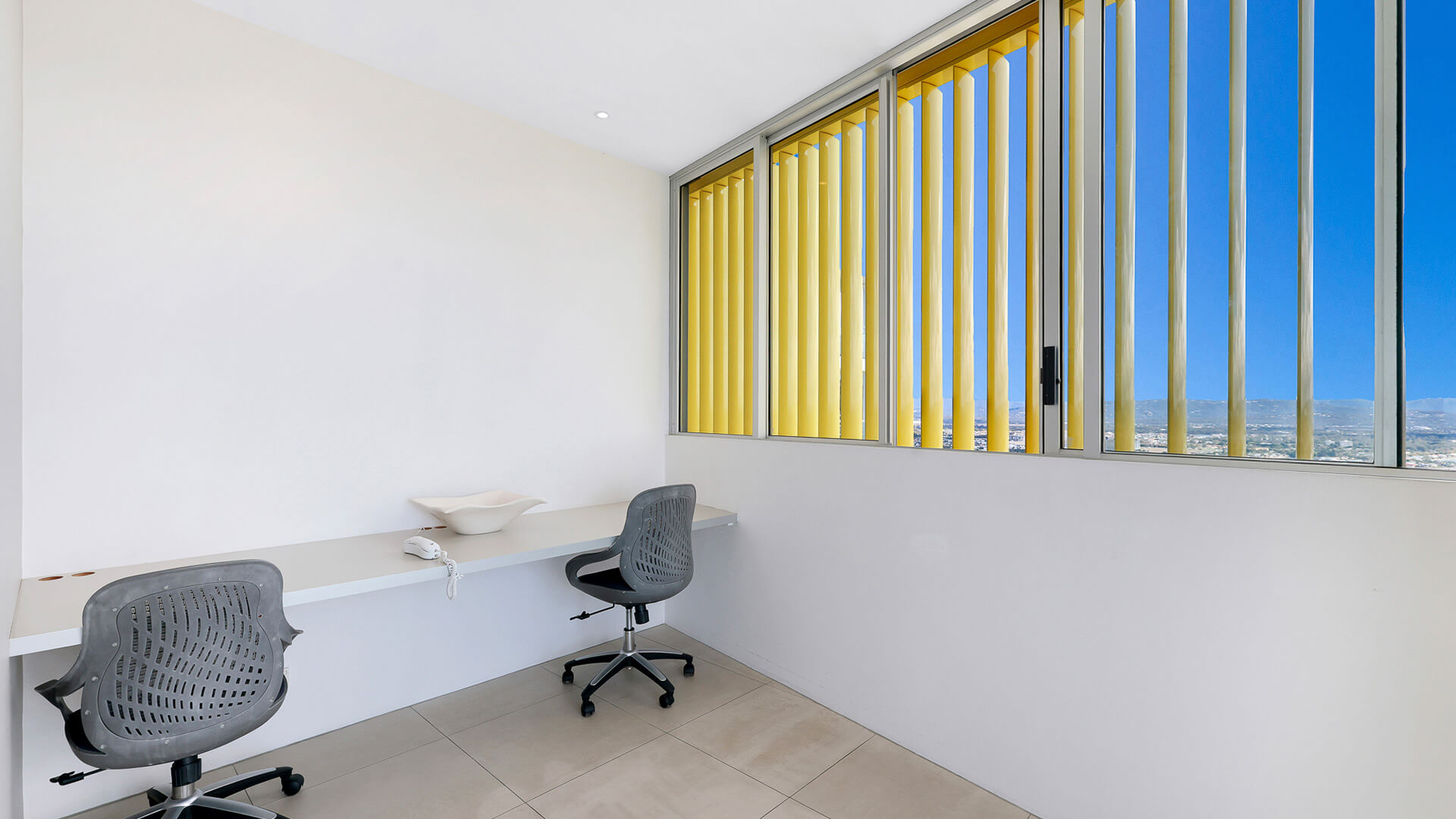 Study area with dual desk and chairs overlooking the city in 4 Bedroom Ocean View Apartment at ULTIQA Air on Broadbeach.