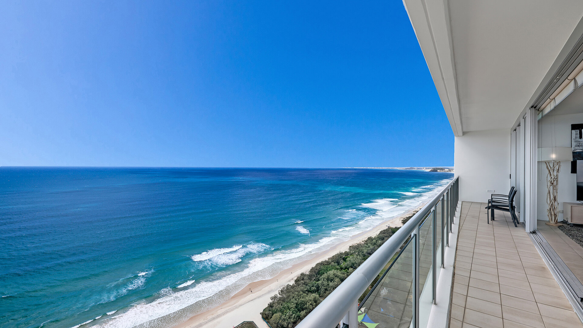 Spacious balcony with seating and panoramic ocean views from 4 Bedroom Ocean View Apartment at ULTIQA Air on Broadbeach.