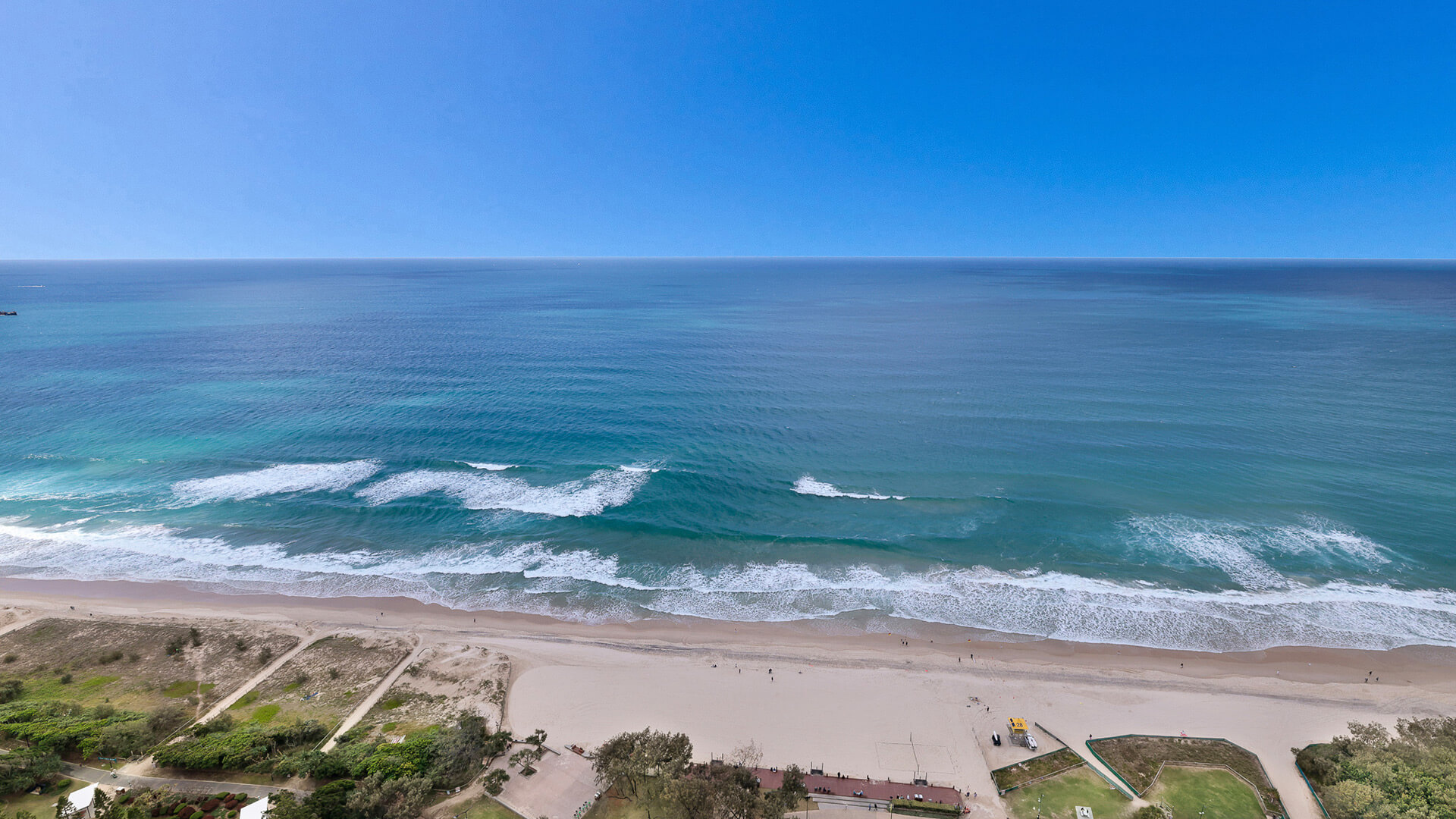 Oceanfront views over golden sand and turquoise water from the 4 Bedroom Ocean View Apartment at ULTIQA Air on Broadbeach.