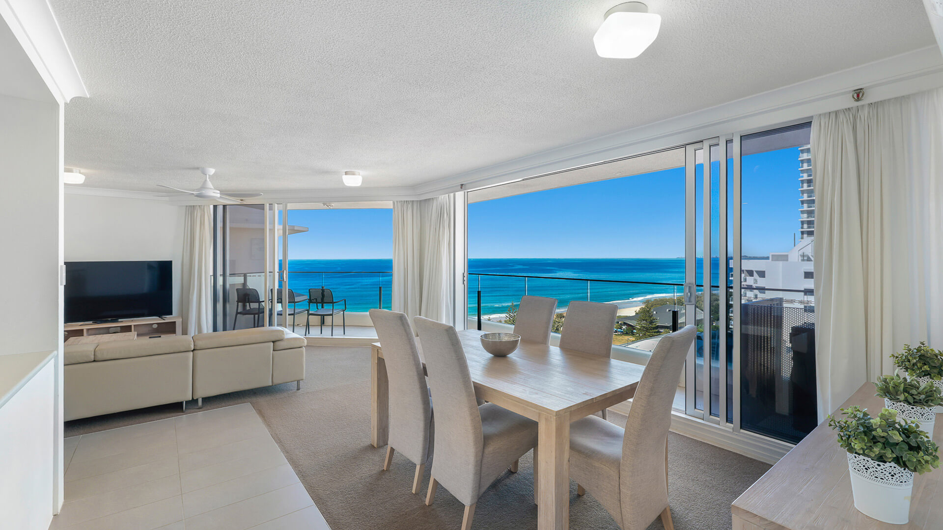Dining and living area in the 2 Bedroom Ocean View Apartment at ULTIQA Beach Haven with stunning views over Broadbeach and the Pacific Ocean.