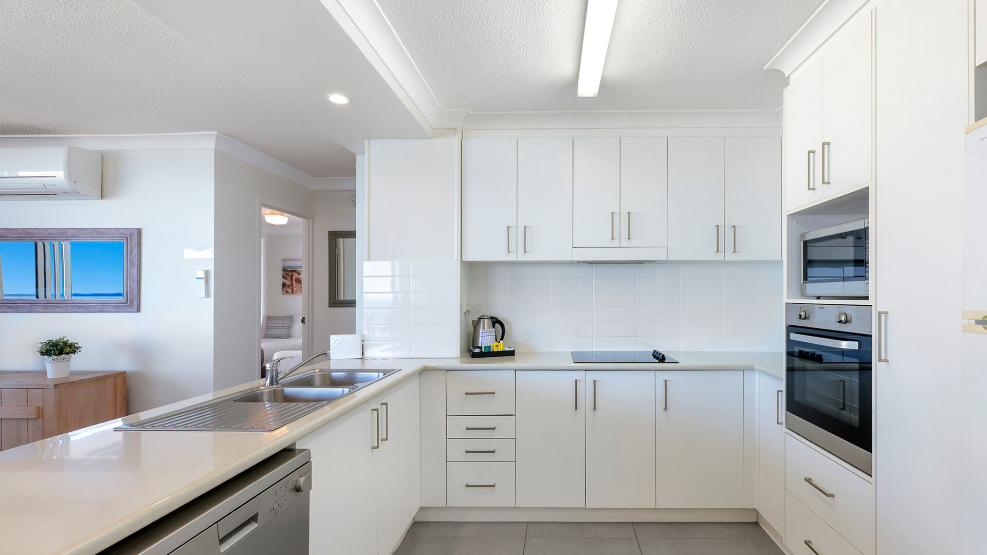 Fully equipped kitchen in the 2 Bedroom Ocean View Apartment at ULTIQA Beach Haven with modern appliances and ample storage.