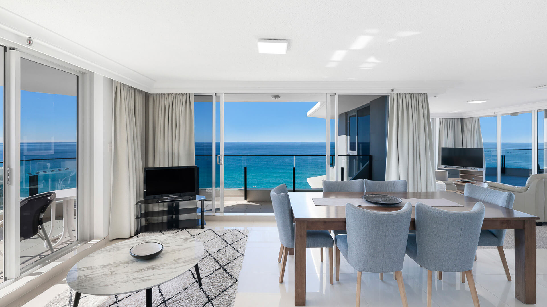 Dining and lounge area with stunning ocean views in the Sub Penthouse at ULTIQA Beach Haven.