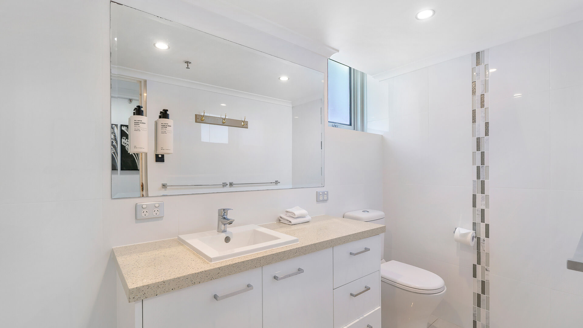 Bright bathroom with walk-in shower in the Sub Penthouse at ULTIQA Beach Haven.