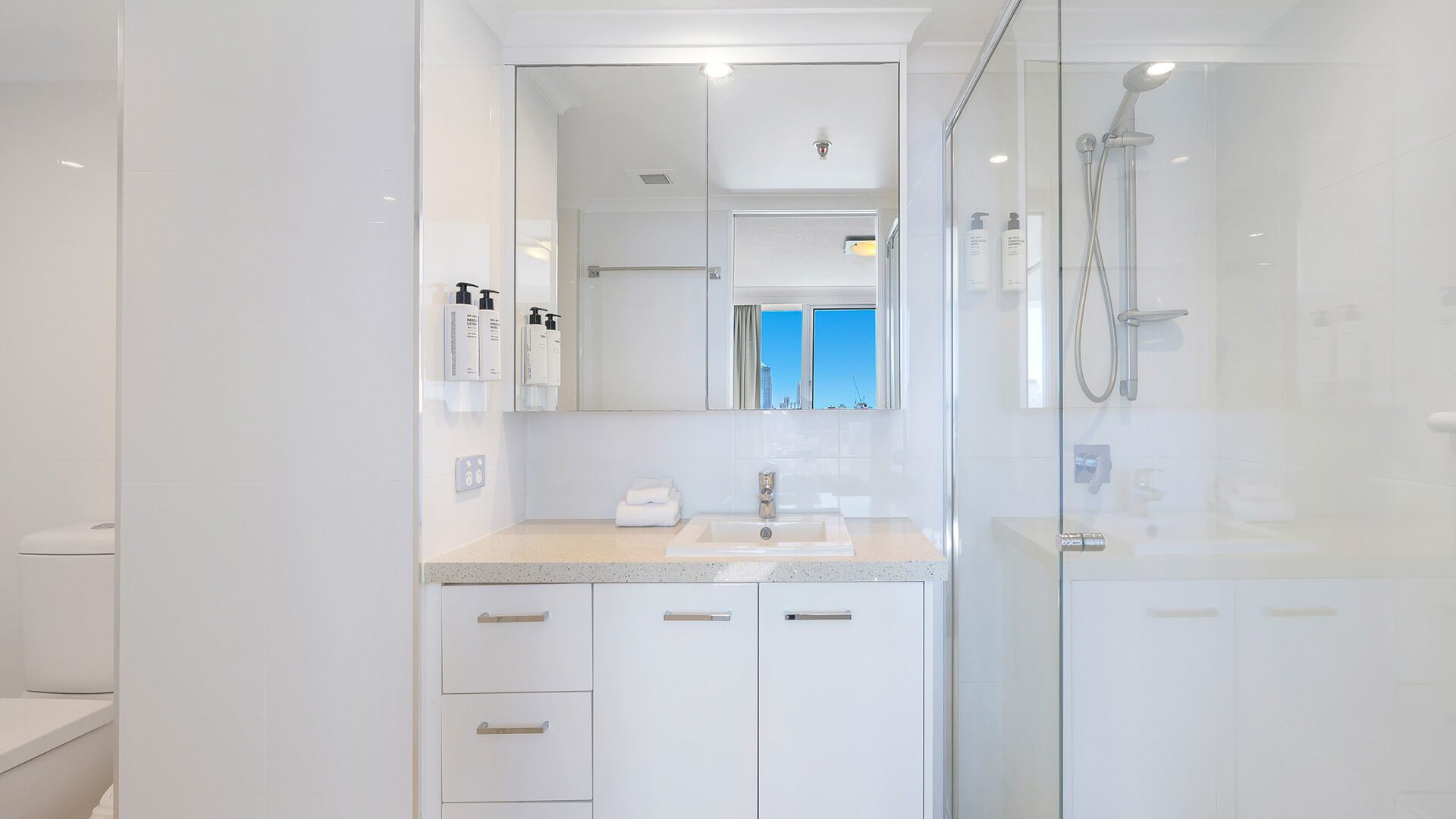 Bright ensuite in the Sub Penthouse at ULTIQA Beach Haven, featuring a walk-in shower and large mirrored vanity.