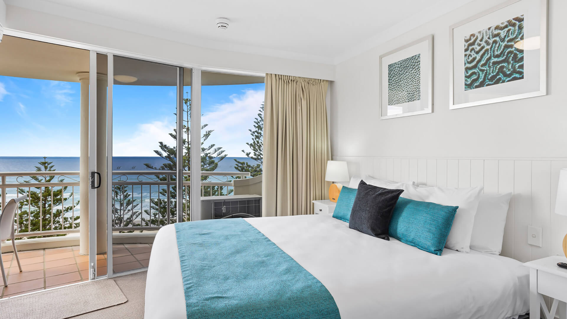 Ocean-facing bedroom featuring a king bed, private balcony access, and breathtaking coastal views.
