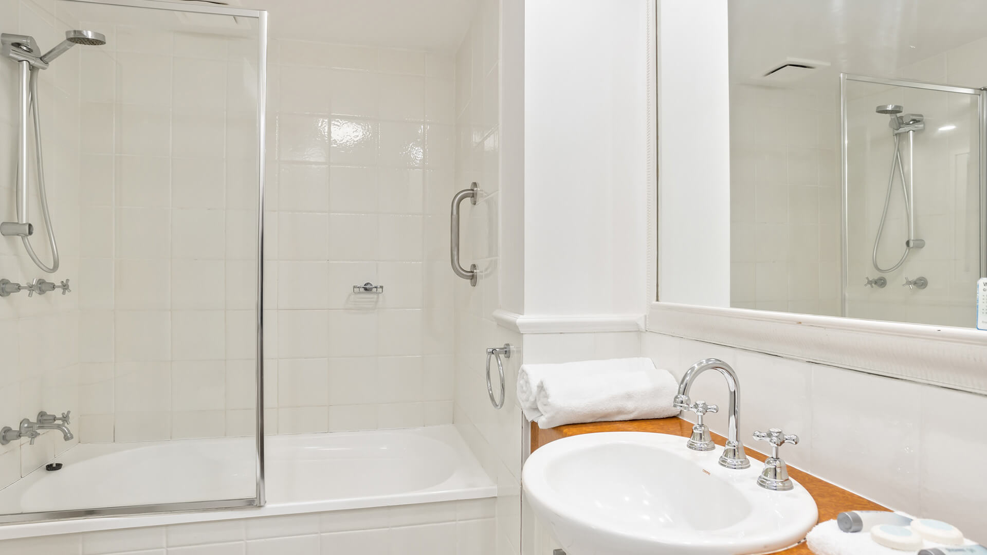 Bathroom with shower over bath in 2 Bedroom Garden View Apartment at ULTIQA Burleigh Mediterranean Resort.