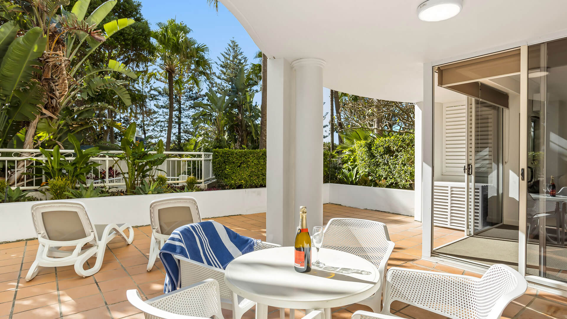 Private garden-view patio with outdoor seating in 2 Bedroom Garden View Apartment at ULTIQA Burleigh Mediterranean Resort.