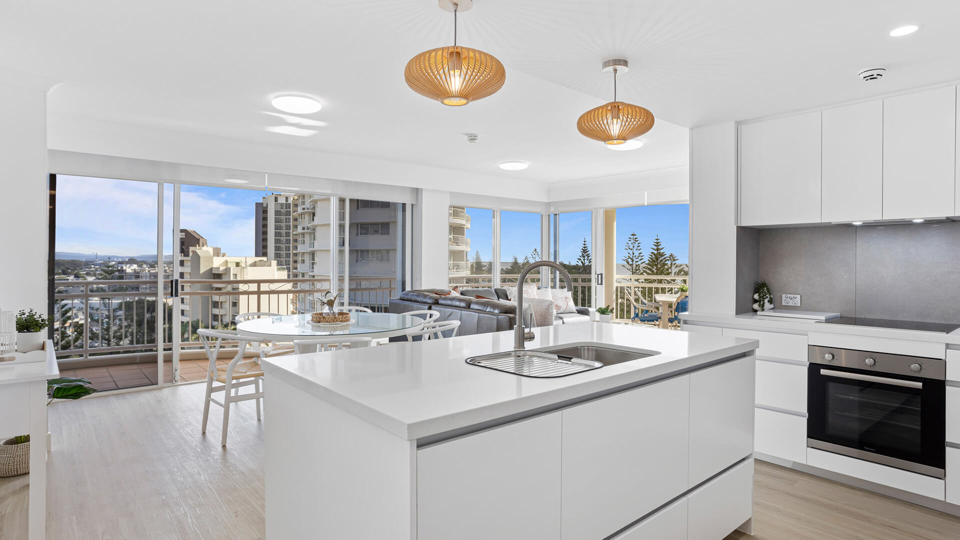 Modern kitchen with island bench, premium appliances, and ocean views in 3 Bedroom Superior Ocean View Apartment at ULTIQA Burleigh Mediterranean Resort.