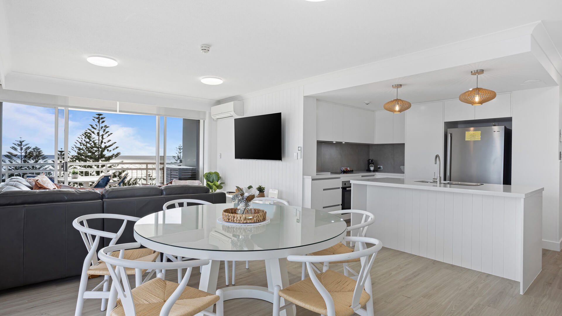 Open-plan dining and kitchen area with ocean views in 3 Bedroom Superior Ocean View Apartment at ULTIQA Burleigh Mediterranean Resort.