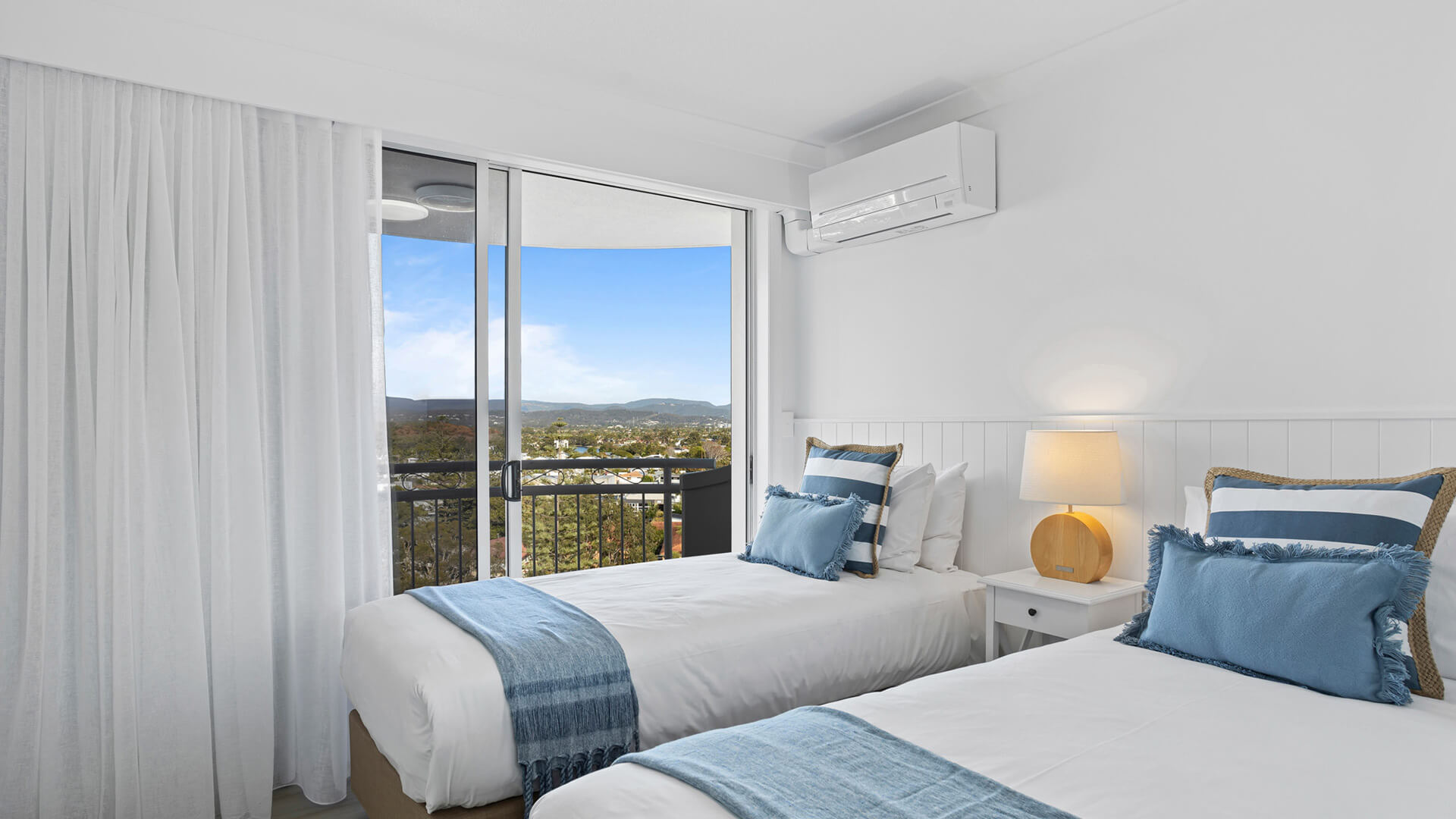 Twin bedroom with balcony and scenic views in the 3 Bedroom Superior Ocean View Apartment at ULTIQA Burleigh Mediterranean Resort.