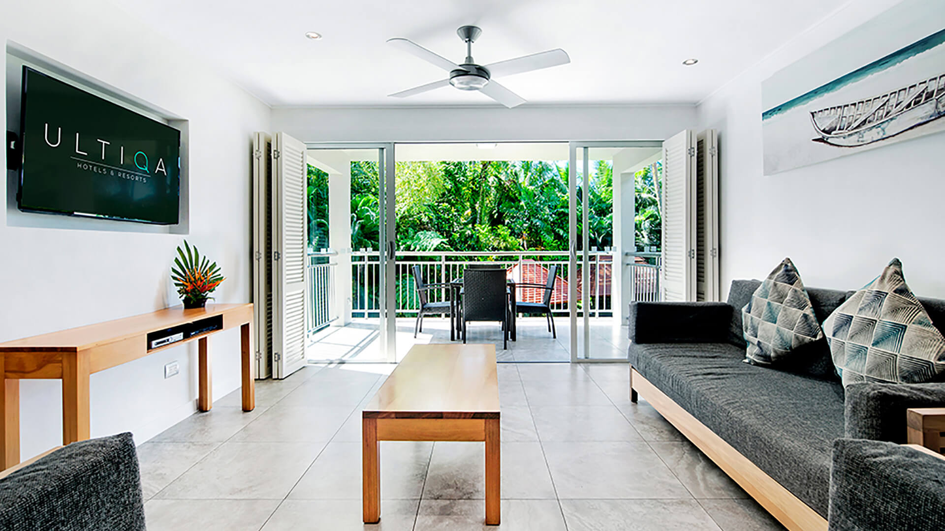 Modern 2 Bedroom Deluxe Apartment at ULTIQA Fiji featuring open-plan living area, balcony with tropical views, and contemporary furnishings.