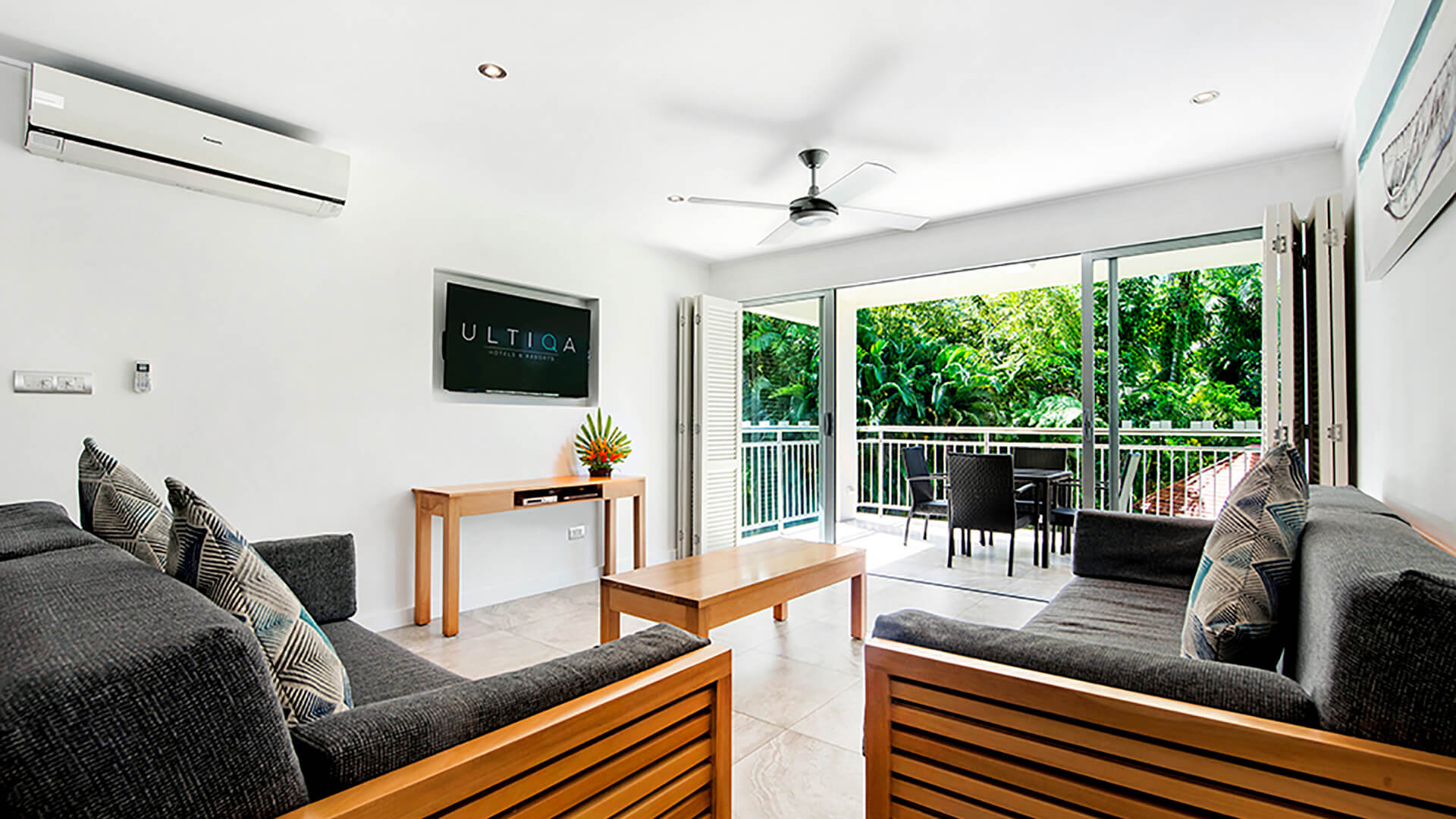 Bright 2 Bedroom Deluxe Apartment at ULTIQA Fiji with stylish lounge, balcony seating, and lush tropical garden views.