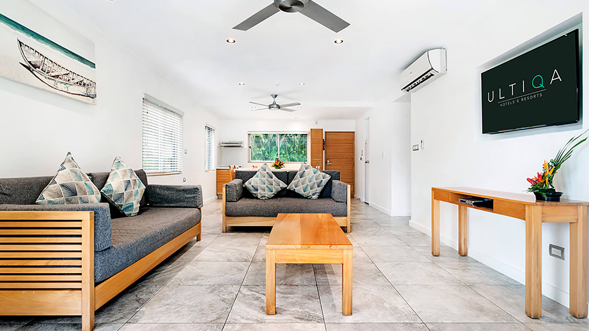 Spacious 2 Bedroom Deluxe Apartment at ULTIQA Fiji with open-plan living, modern decor, and comfortable seating area.