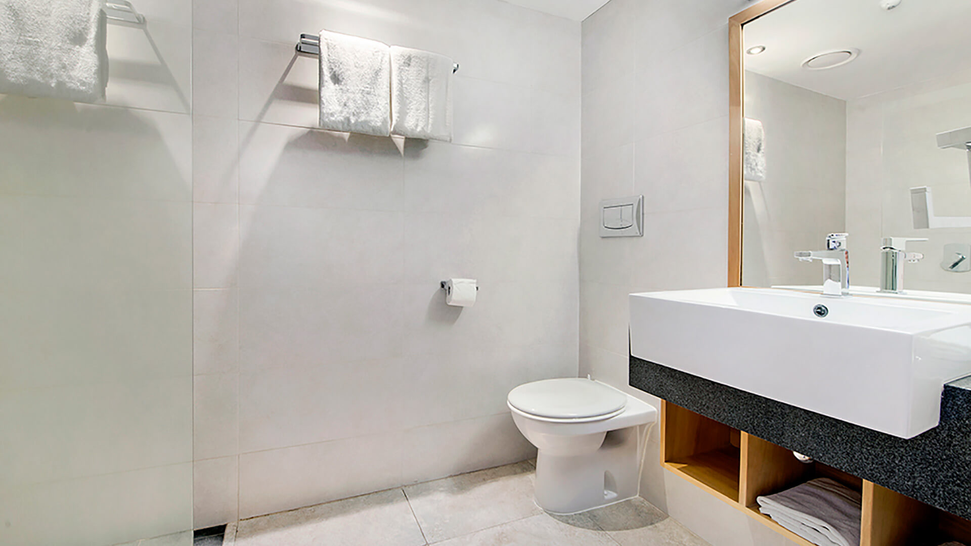 Modern bathroom in 2 Bedroom Deluxe Apartment at ULTIQA Fiji with walk-in shower, vanity, and contemporary finishes.