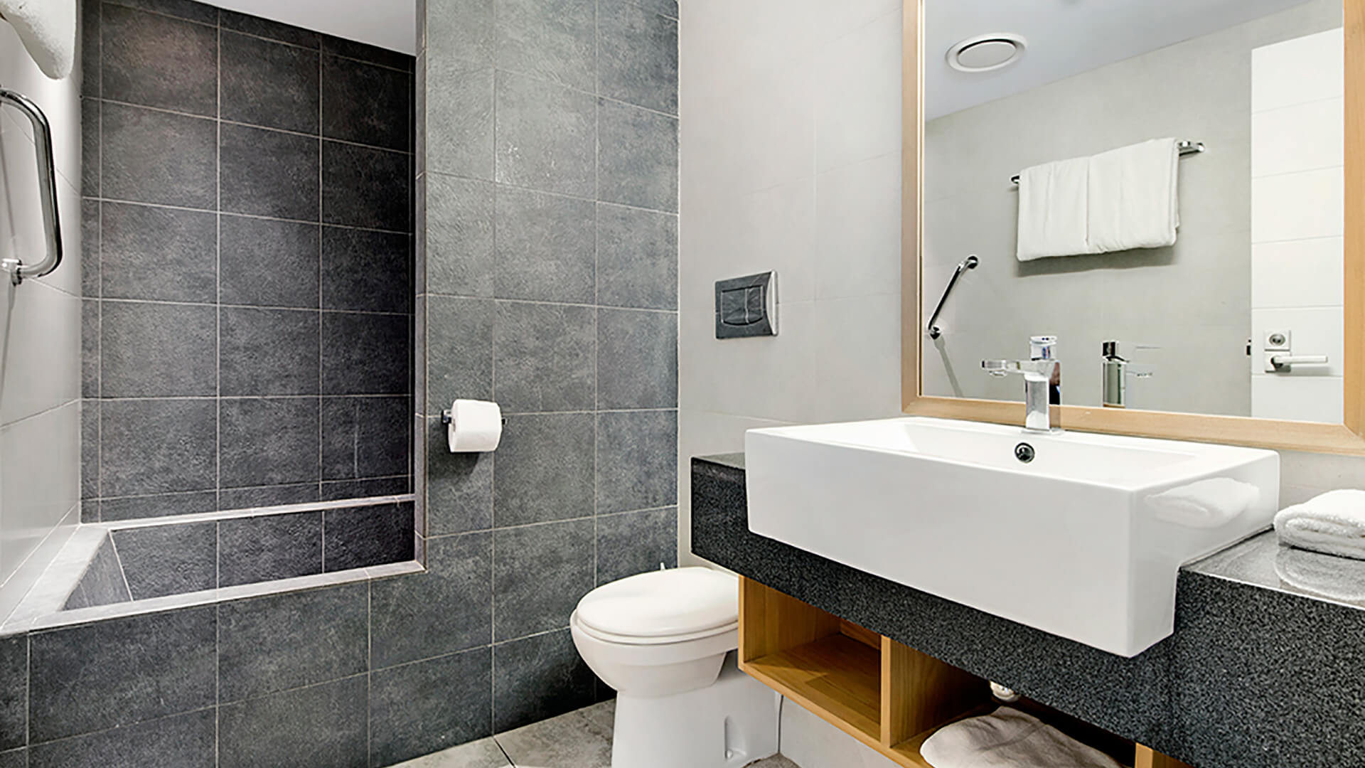 Modern bathroom in 2 Bedroom Deluxe Apartment at ULTIQA Fiji with bathtub, vanity, and sleek contemporary design.