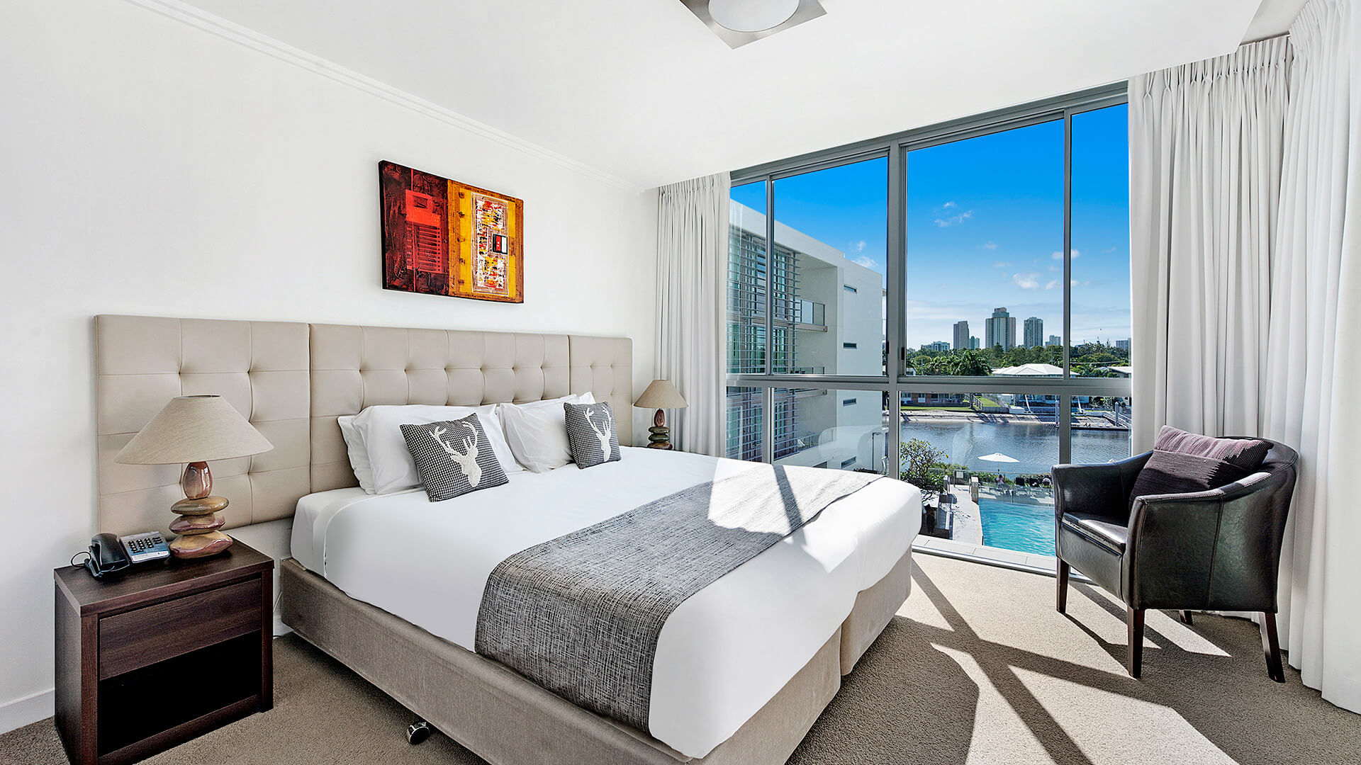 1 Bedroom Apartment at ULTIQA Freshwater Point Resort featuring a king bed, natural light, and waterway views.