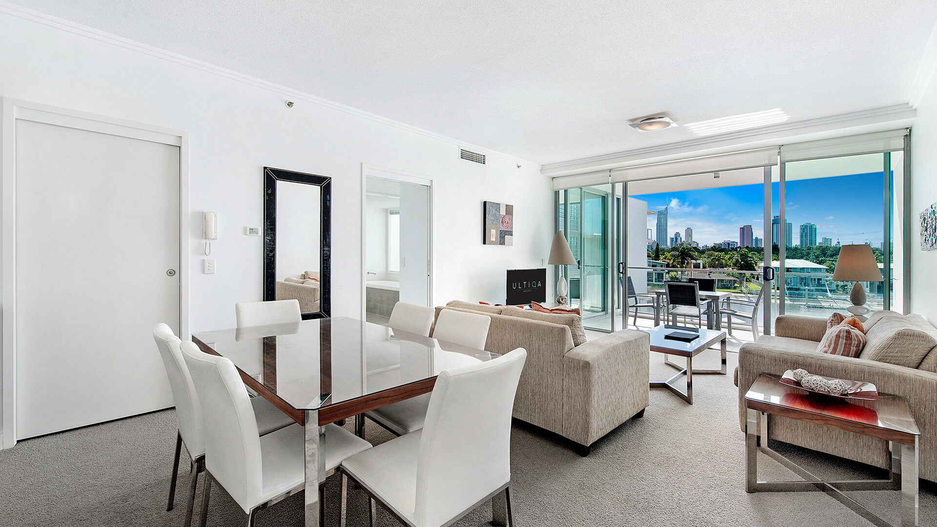 Open-plan living and dining area in the 1 Bedroom Apartment at ULTIQA Freshwater Point Resort, with balcony views and natural light.
