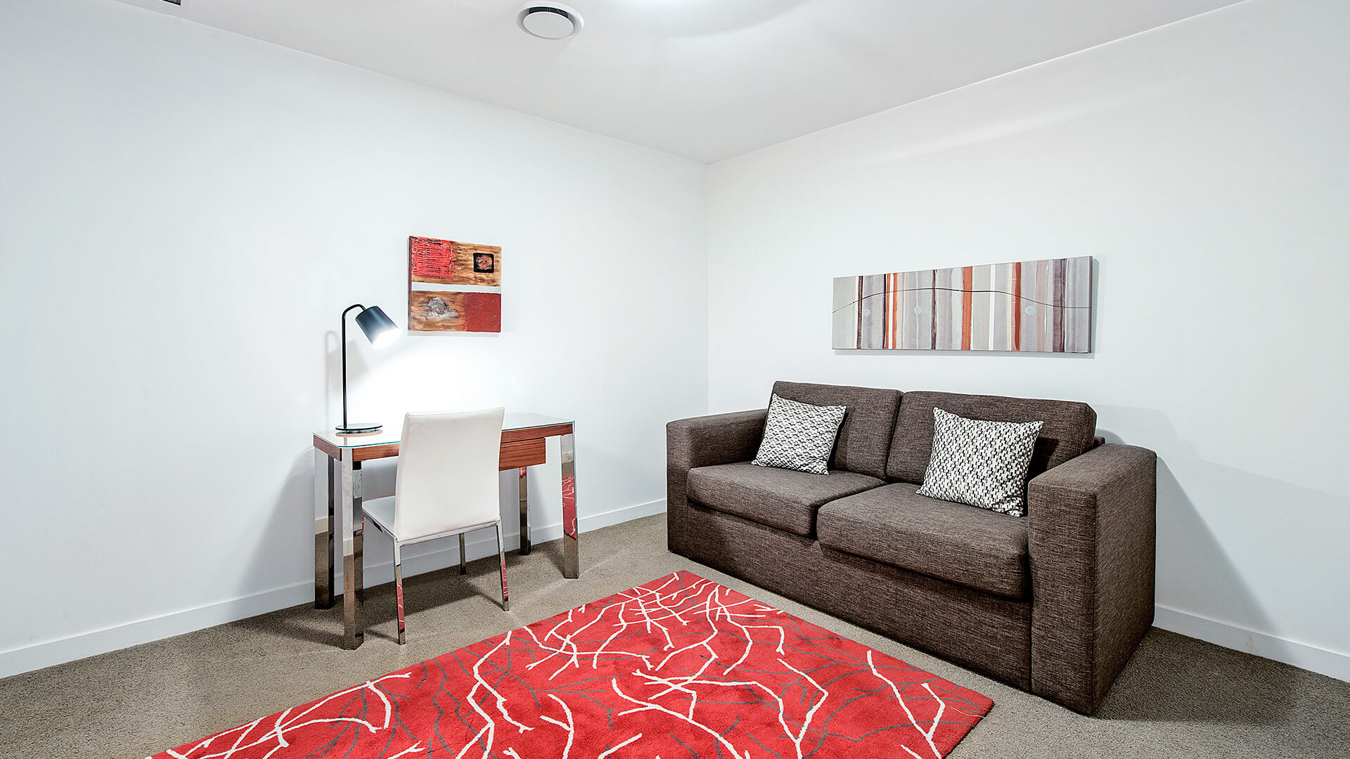 Separate study nook with desk and sofa in the 1 Bedroom Apartment at ULTIQA Freshwater Point Resort.