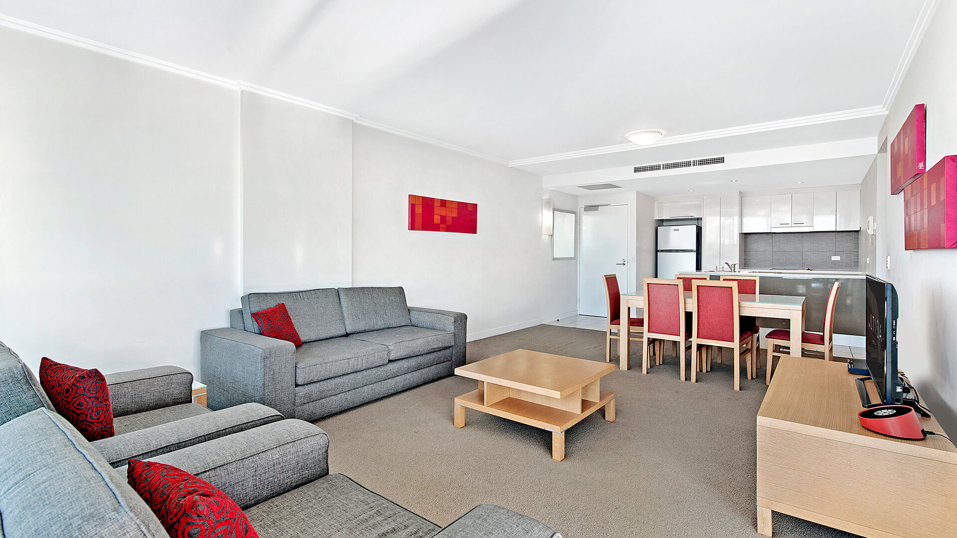 Open-plan lounge, dining, and kitchen in the 2 Bedroom Apartment at ULTIQA Freshwater Point Resort, ideal for families and longer stays.