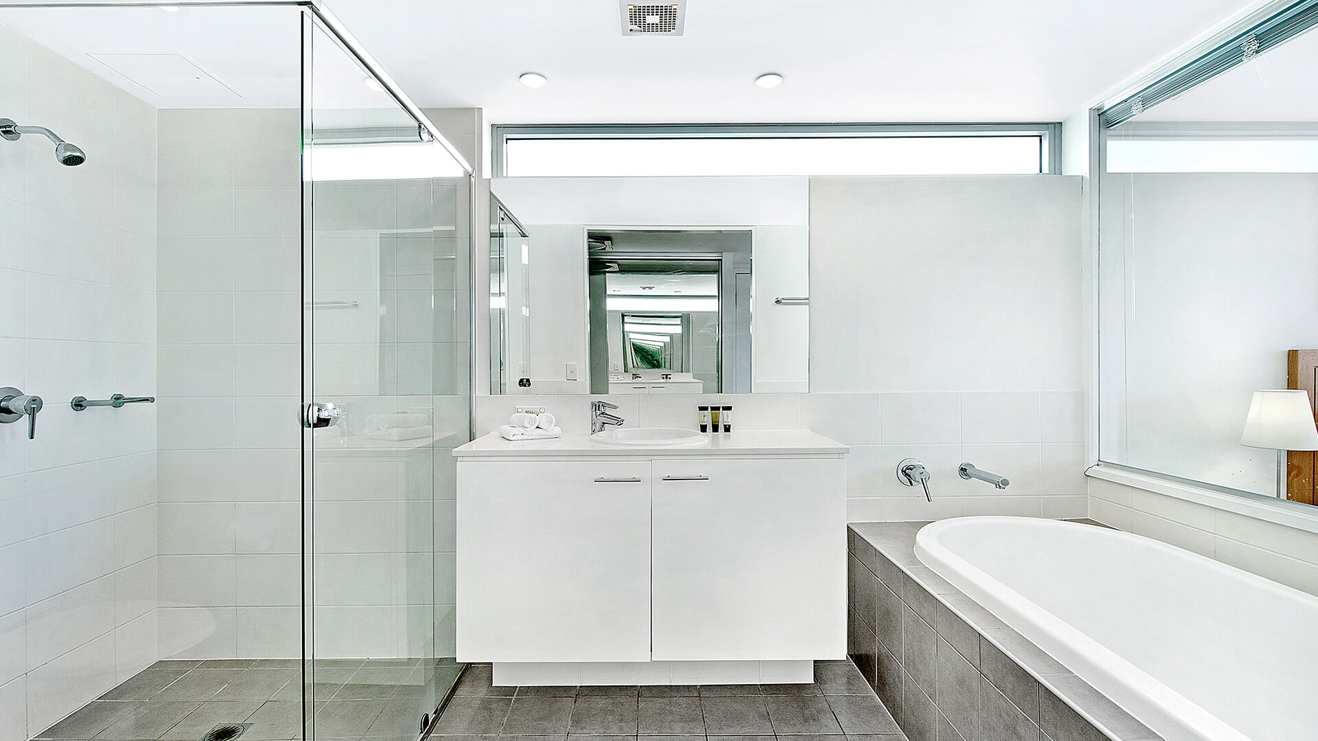Ensuite bathroom in the 2 Bedroom Apartment at ULTIQA Freshwater Point Resort, featuring a walk-in shower, bathtub, and double vanity.