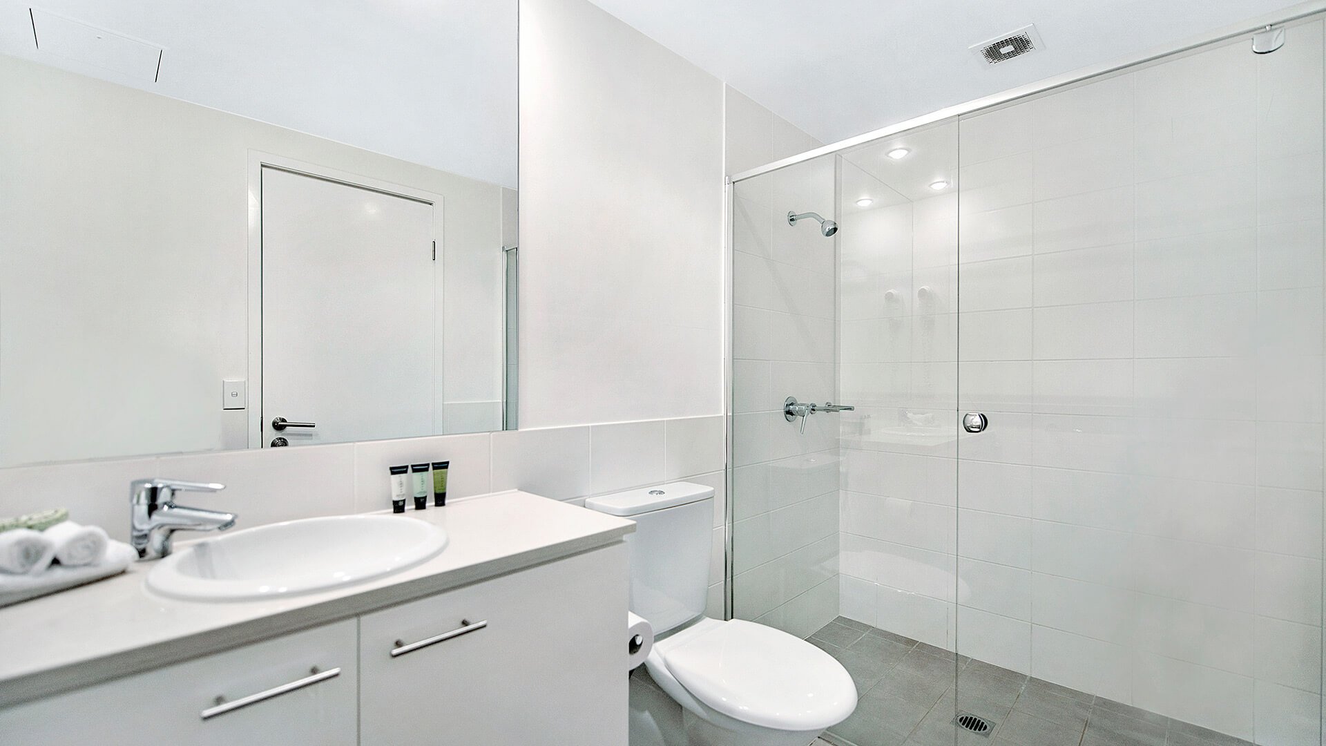 Second bathroom in the 2 Bedroom Apartment at ULTIQA Freshwater Point Resort, complete with walk-in shower, vanity, and complimentary amenities.
