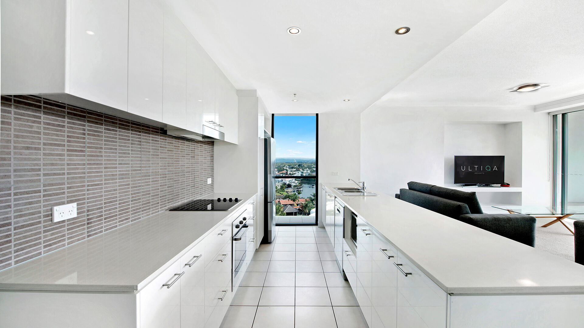 Modern kitchen with full-size appliances and city views in the 3 Bedroom Apartment at ULTIQA Freshwater Point Resort.