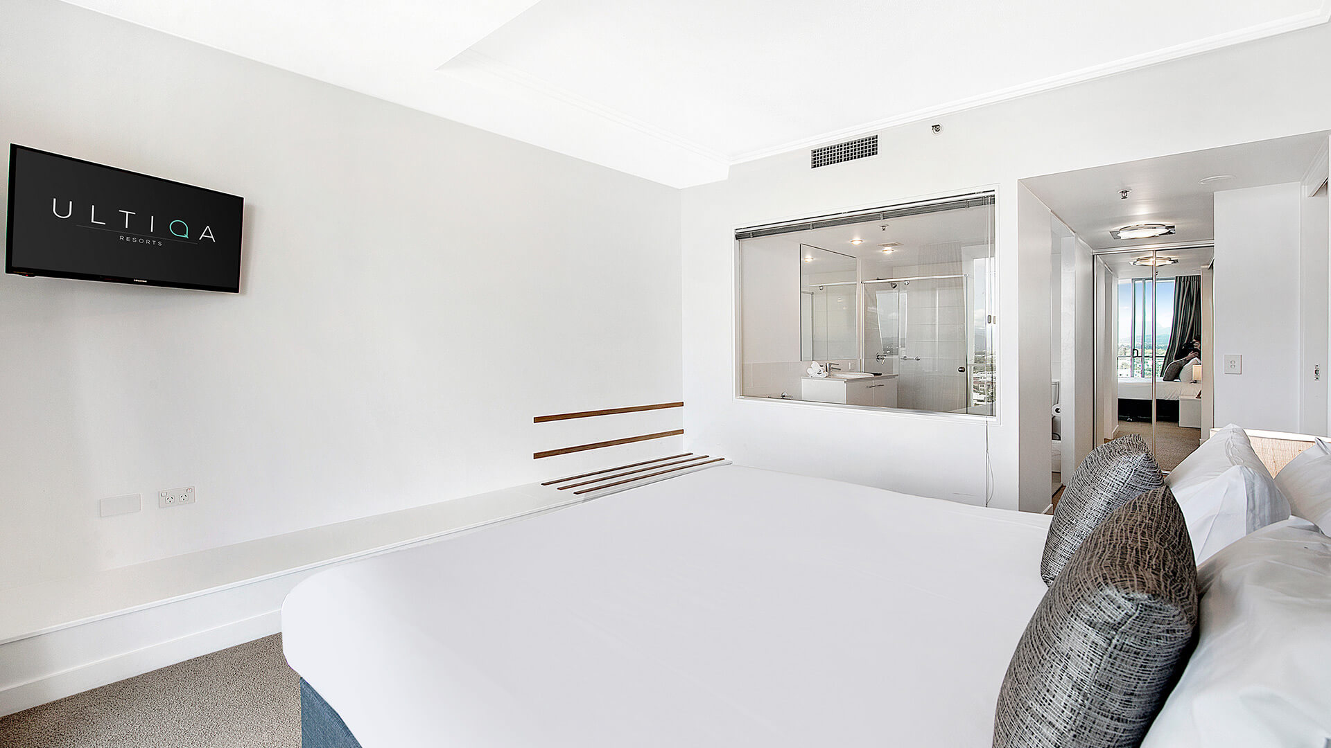 Master bedroom with king bed, ensuite and in-room TV in the 3 Bedroom Apartment at ULTIQA Freshwater Point Resort.
